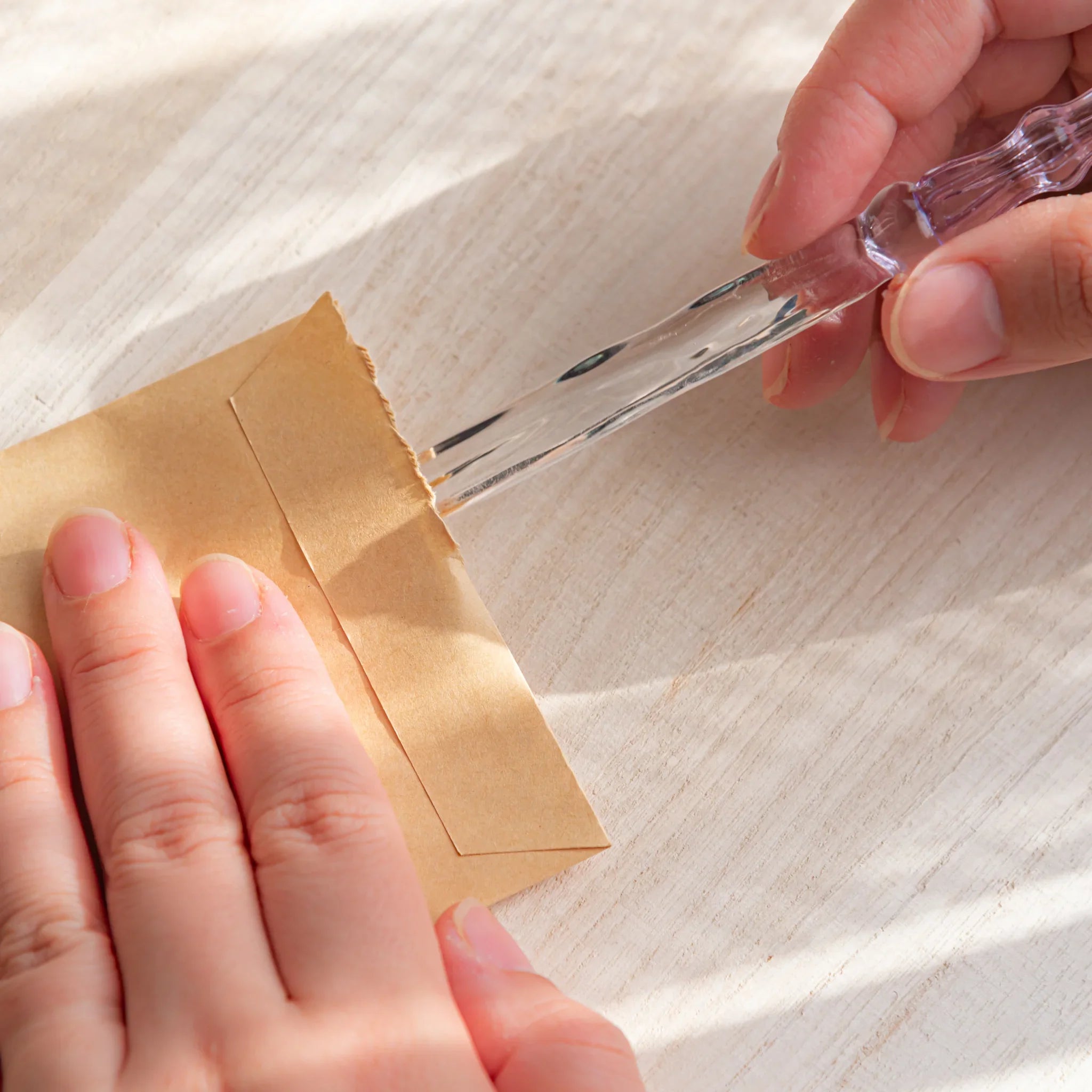 Moonlit cloud glass letter opener with lavender tint shown in composition displayed in composition product composition view