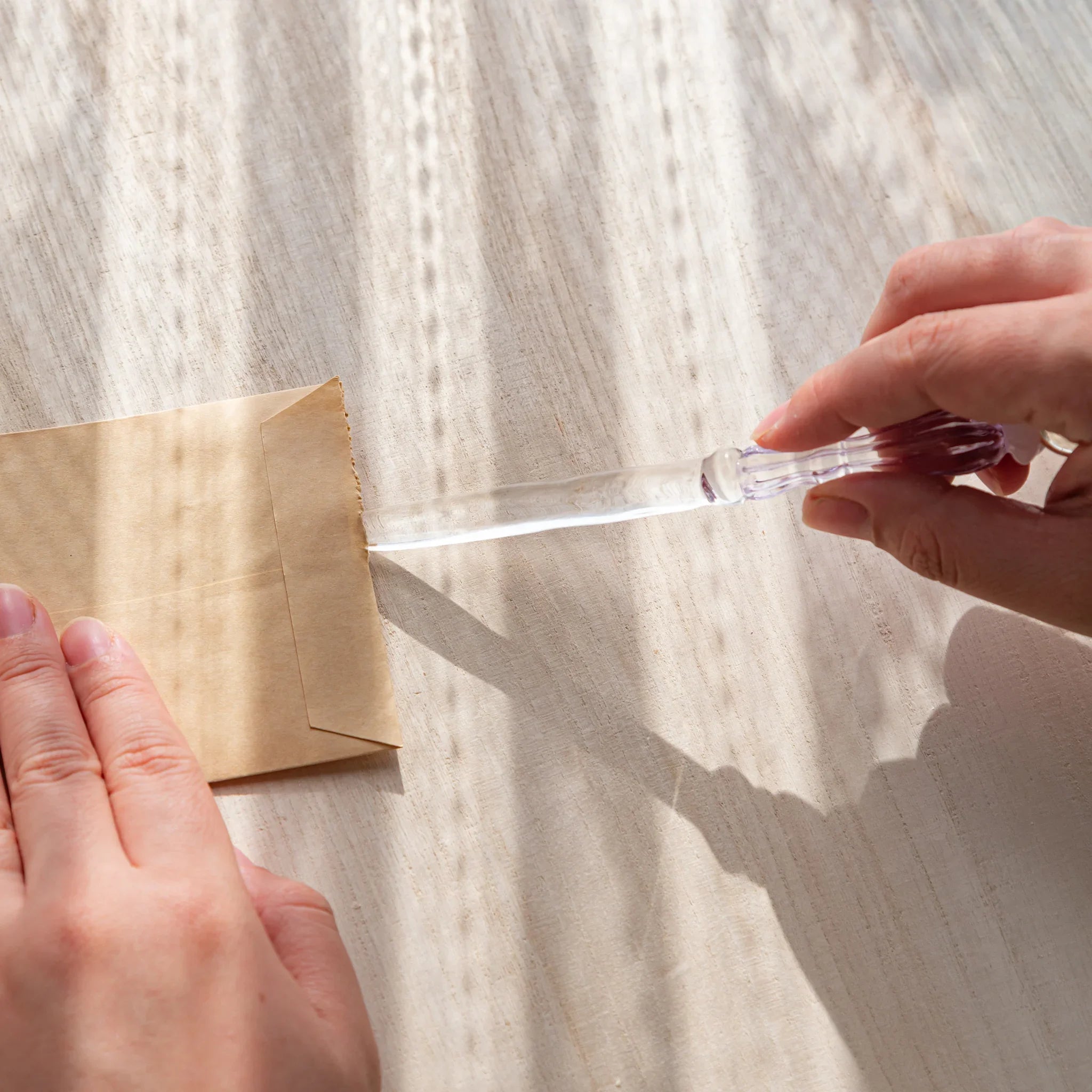 Moonlit cloud glass letter opener with lavender tint shown in composition in detailed composition product composition view