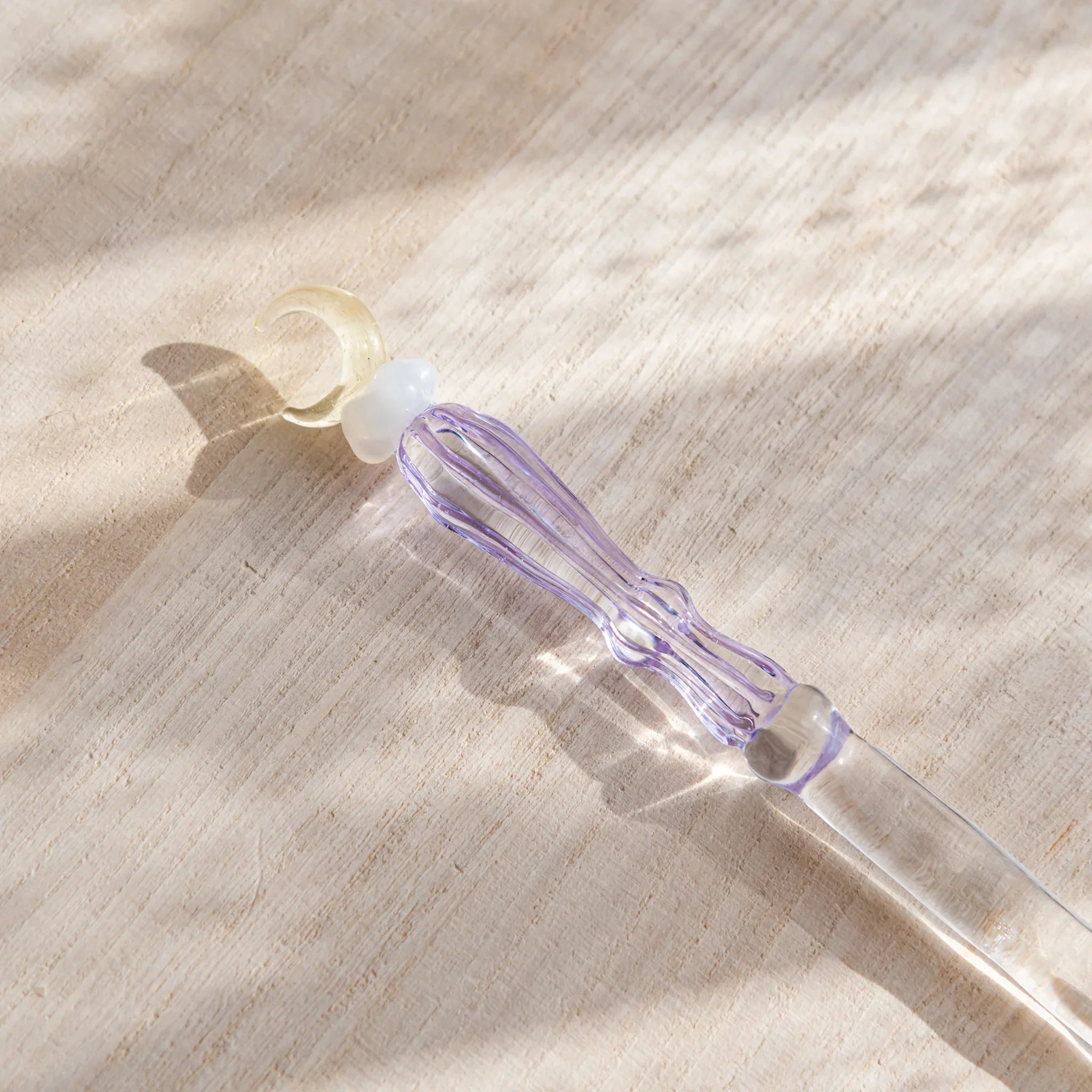 Moonlit cloud glass letter opener with lavender tint shown in composition in composition view product composition view