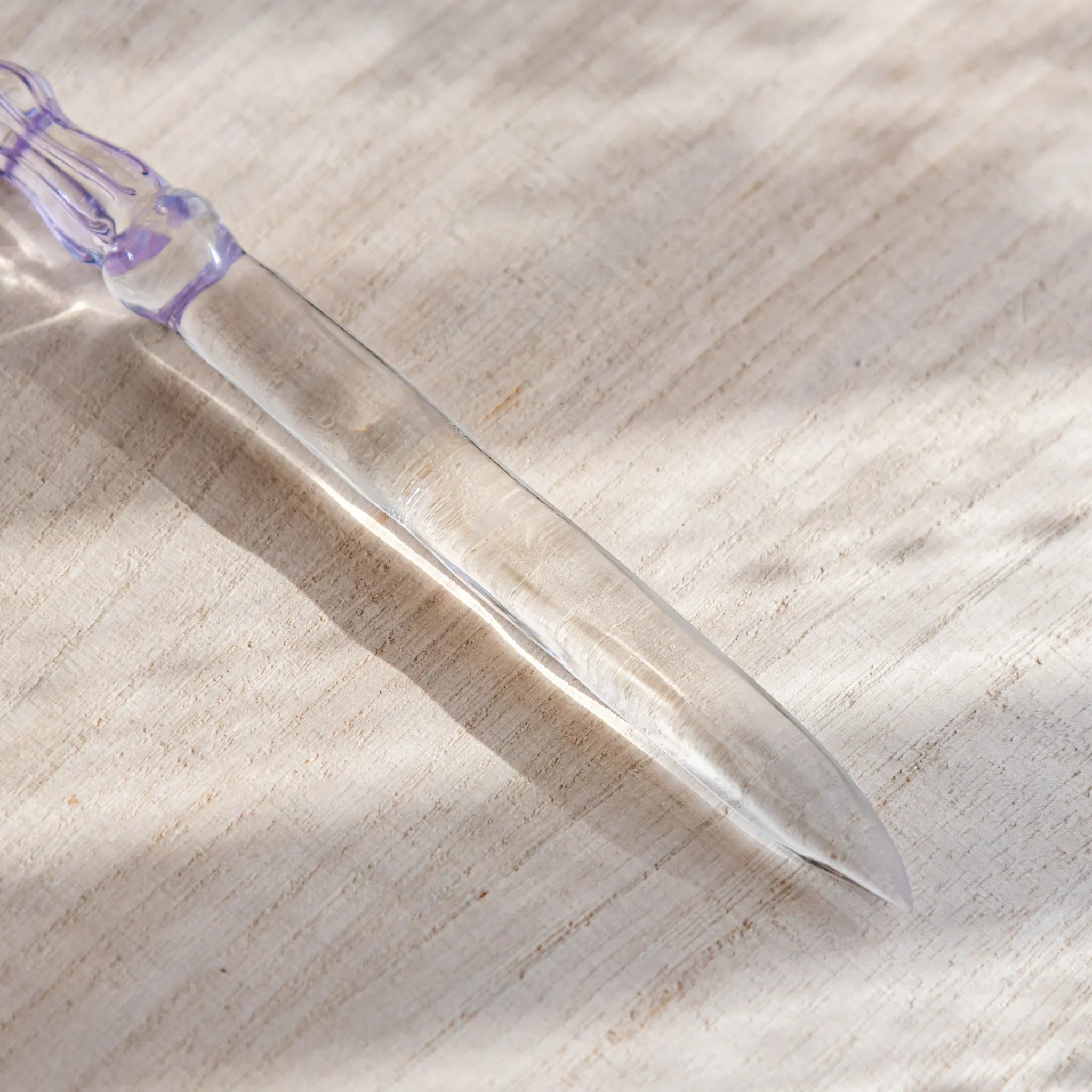 Moonlit cloud glass letter opener with lavender tint shown in composition shown in detail product composition view