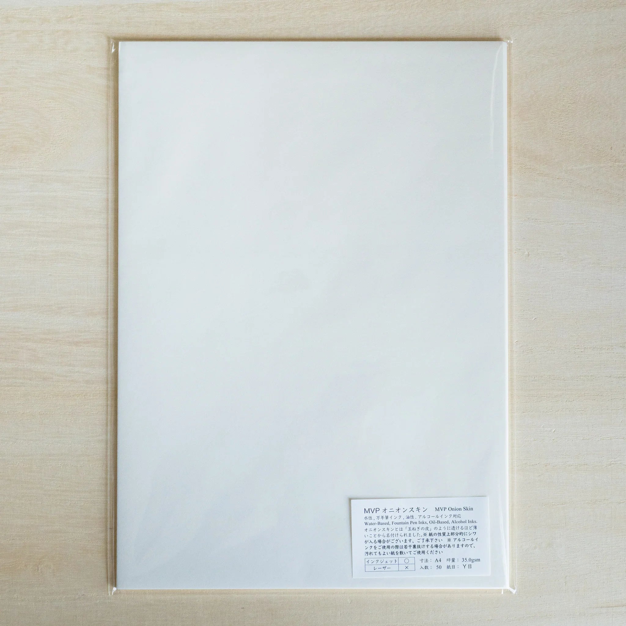 MVP Onion Skin A4 loose leaf paper pack in a clear sleeve on light wood, white Japanese and English label at lower right