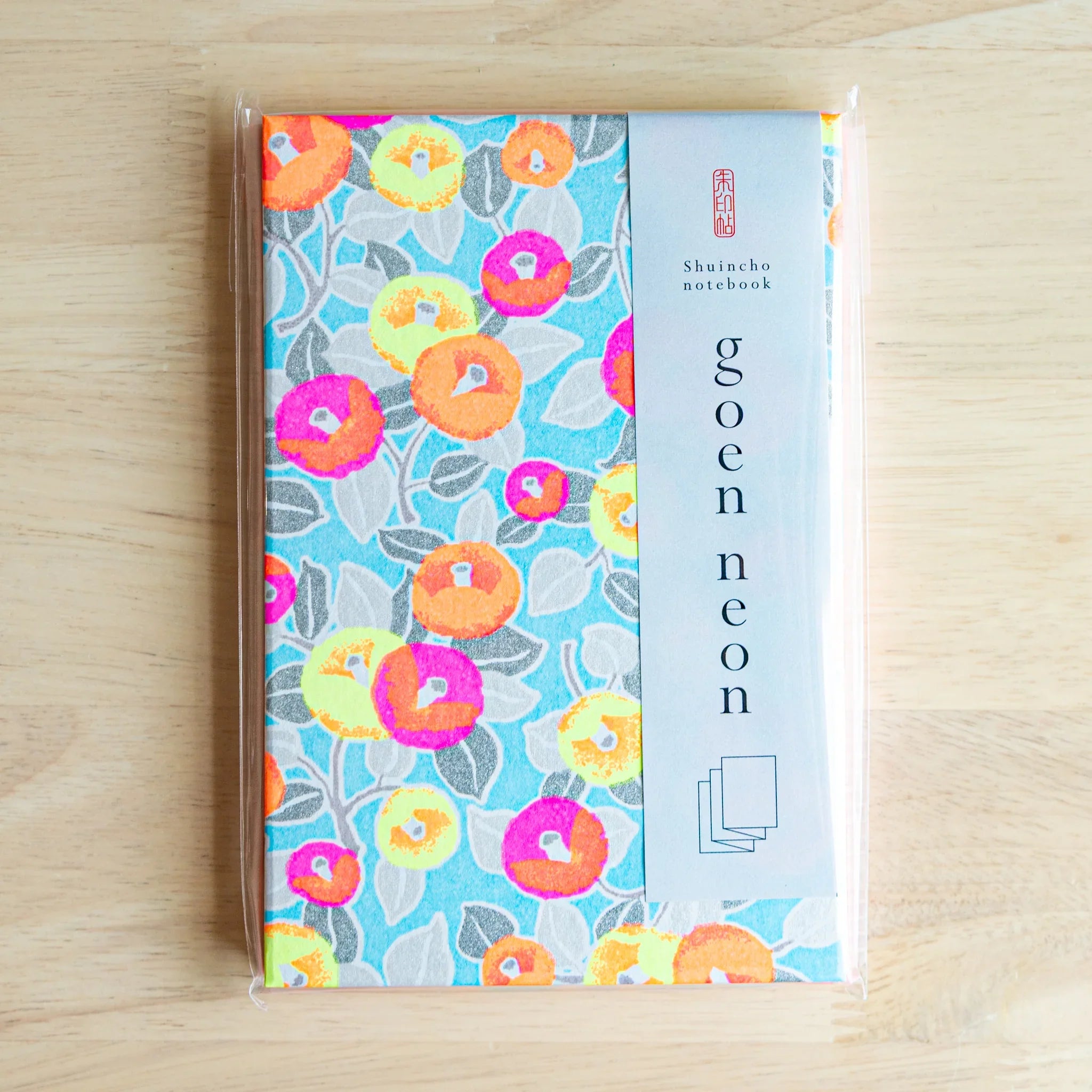 Neon Camellia washi goshuincho in original packaging with light blue goen neon belly band and Shuincho notebook label