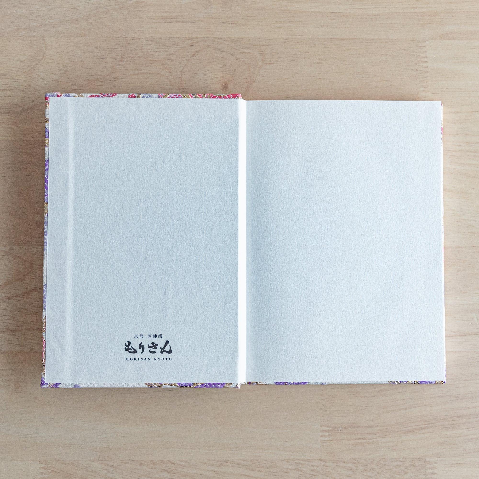 The inner cover of a Japanese notebook with a plain white page featuring the "Morisan Kyoto" logo printed at the bottom.