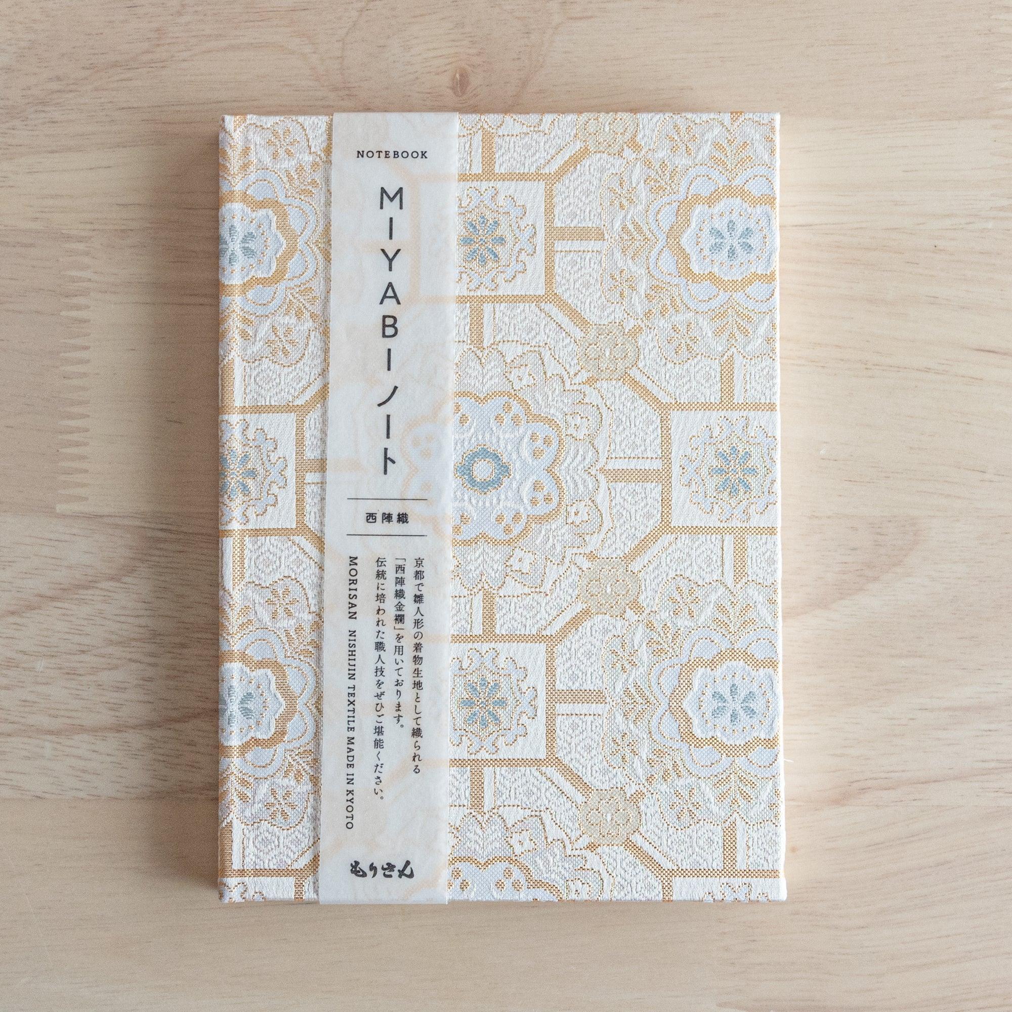The inner cover of a Japanese notebook with plain white pages and the "Morisan Kyoto" logo printed on the bottom left.