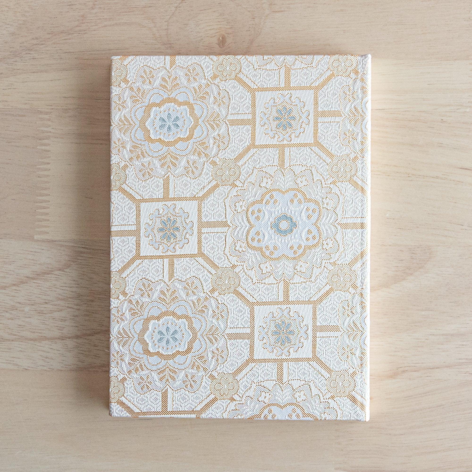 Nishijin textile B6 notebook, flat lay of traditional Shokkou Pattern brocade design detail with binding
