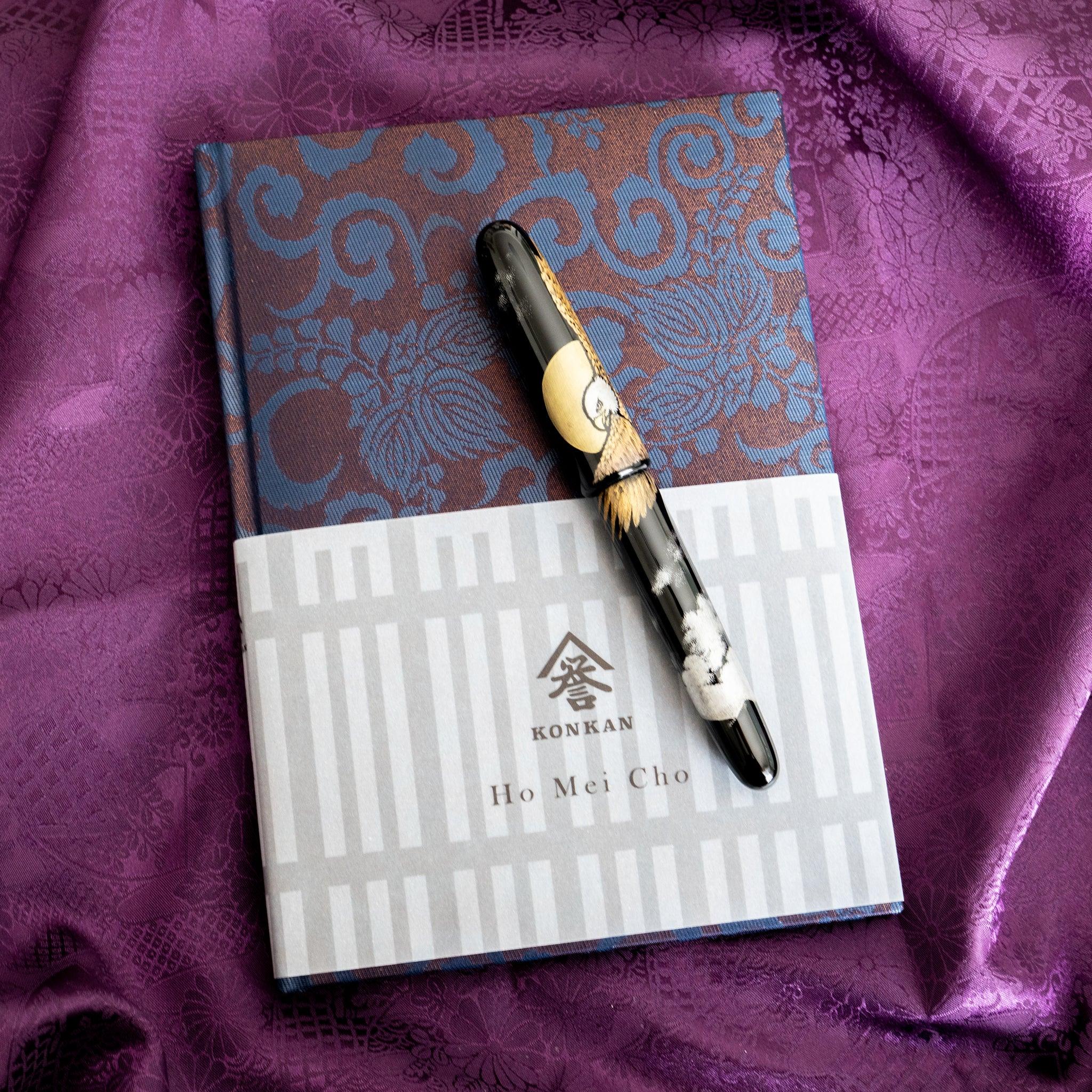 Oni Kiri Nishijin silk Homeicho notebook with KONKAN Ho Mei Cho band and maki-e fountain pen on purple fabric