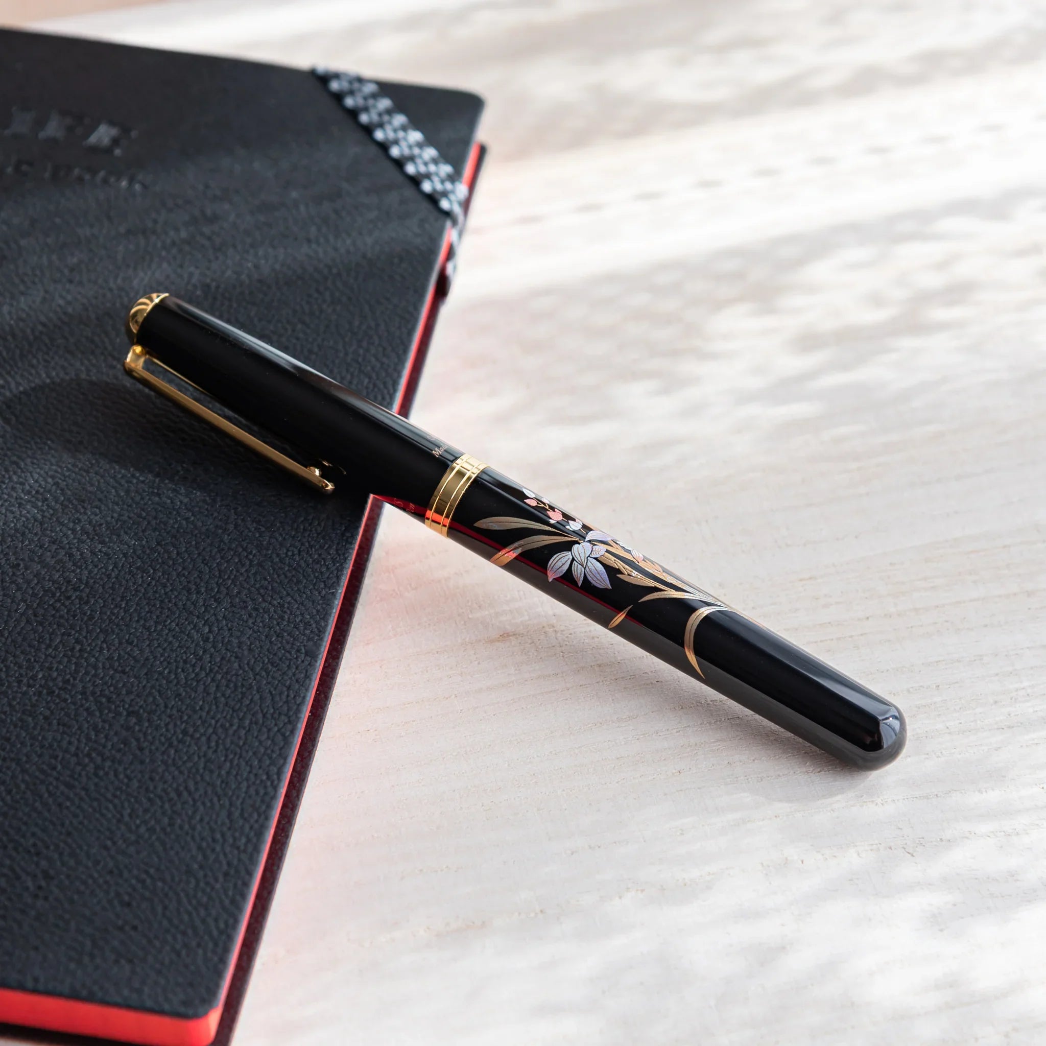 Orchid flower Yamanaka fountain pen with lacquer design shown in composition shown in detail view product composition view