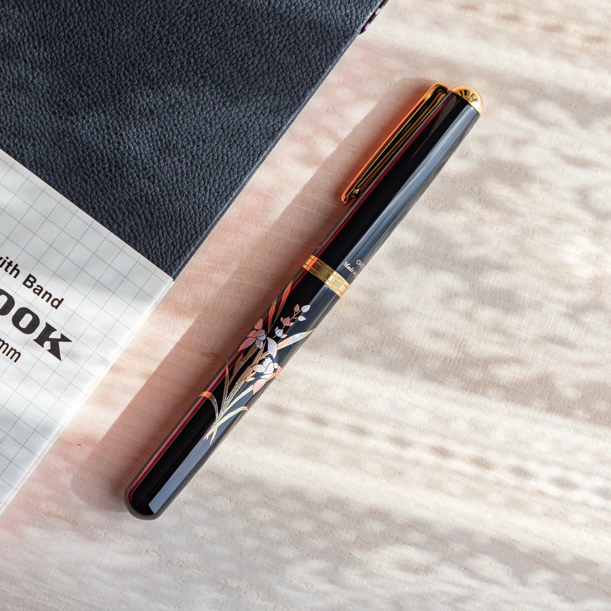 Orchid flower Yamanaka fountain pen with lacquer design shown in composition in composition view product composition view