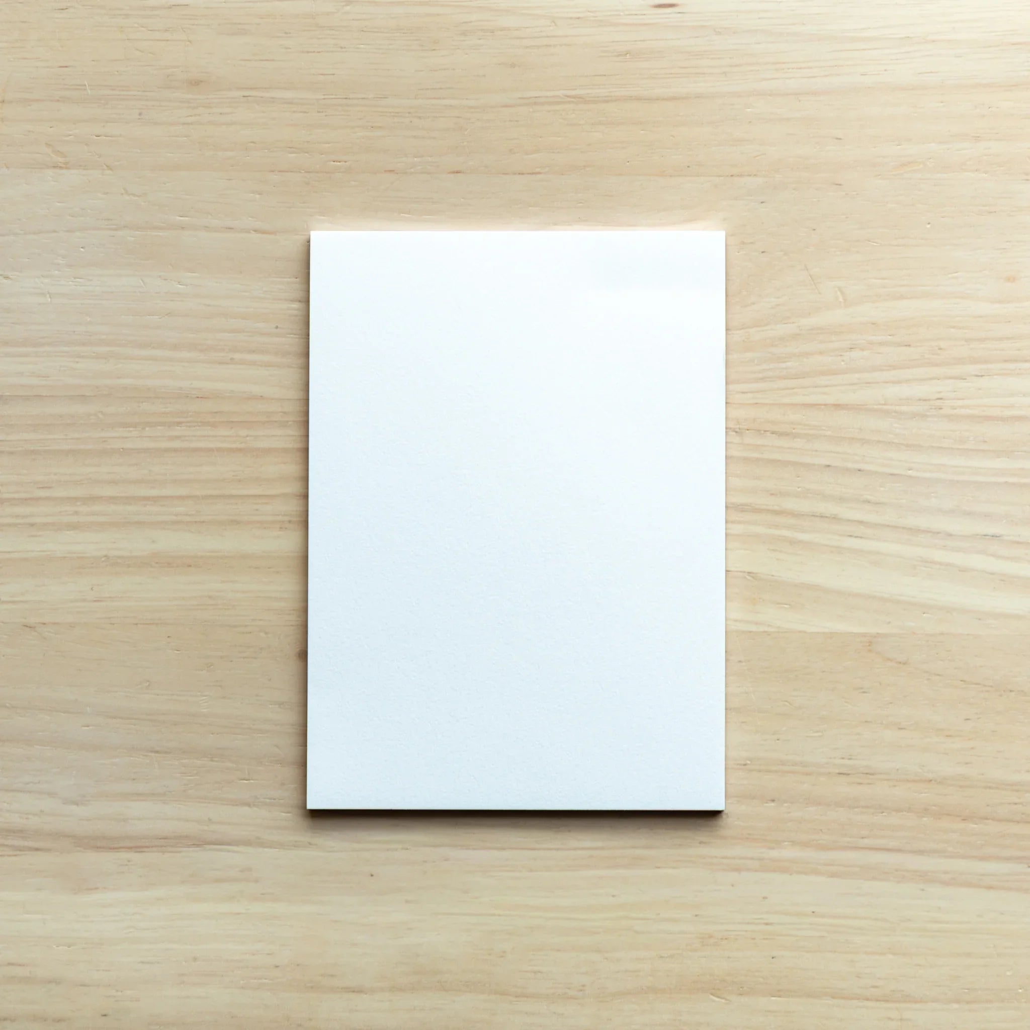 Paper Tasting egg shell sample sheets fanned out, showing neutral cream and white paper tones and textures