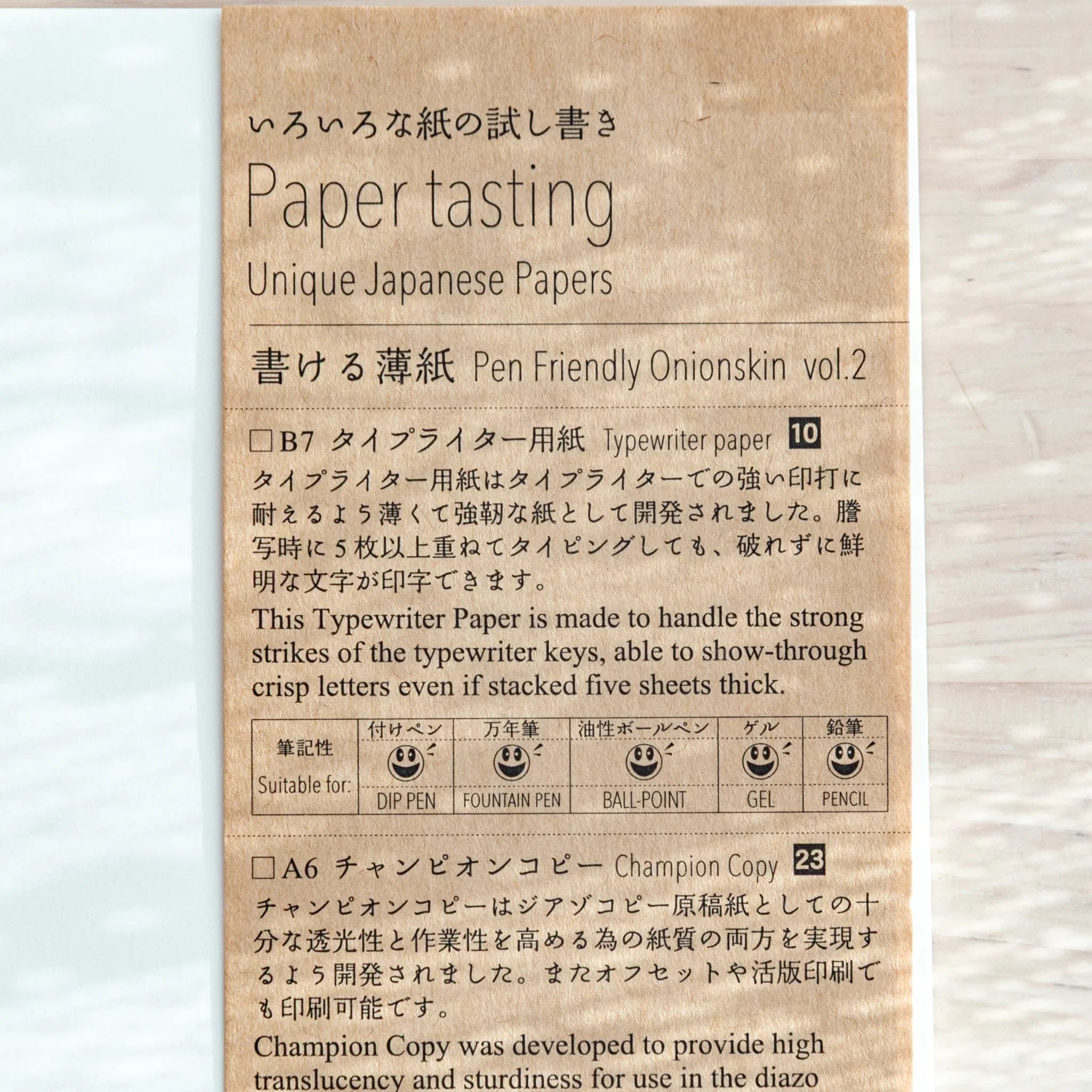 Hand flipping thin onionskin paper pages demonstrating delicate handling and page turning characteristics of pad
