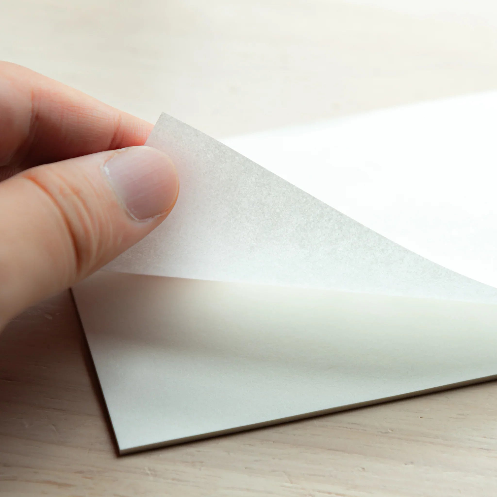 Open onionskin paper pad revealing ultra-thin blank sheets prepared for writing with smooth pen performance ready