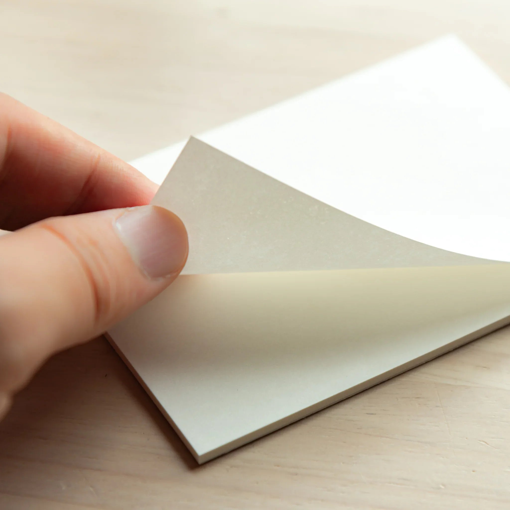 Open silky paper pad showing blank sheets ready for writing with refined smooth paper surface visible quality