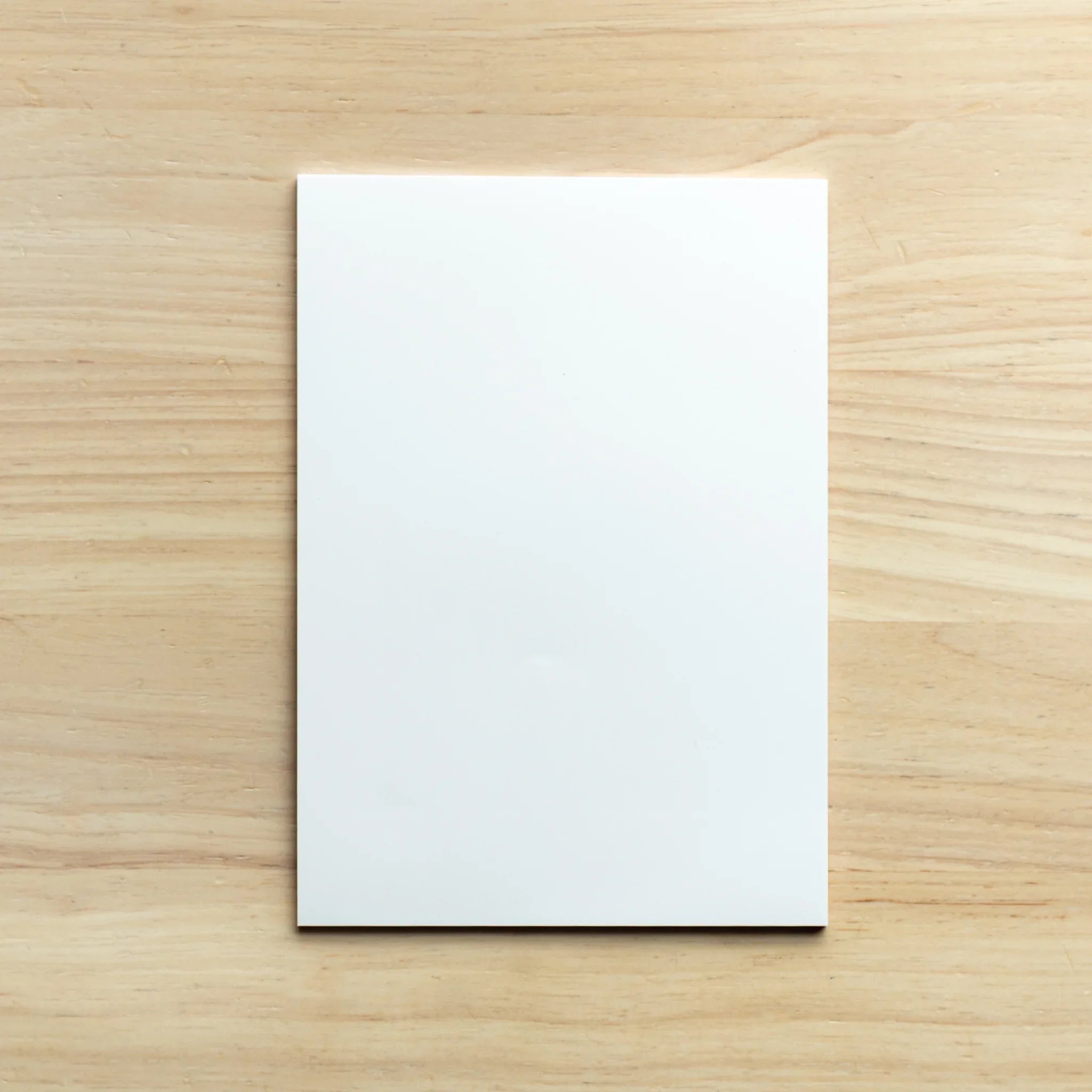 Close-up detail of silky paper texture showing smooth refined surface coating under natural lighting conditions