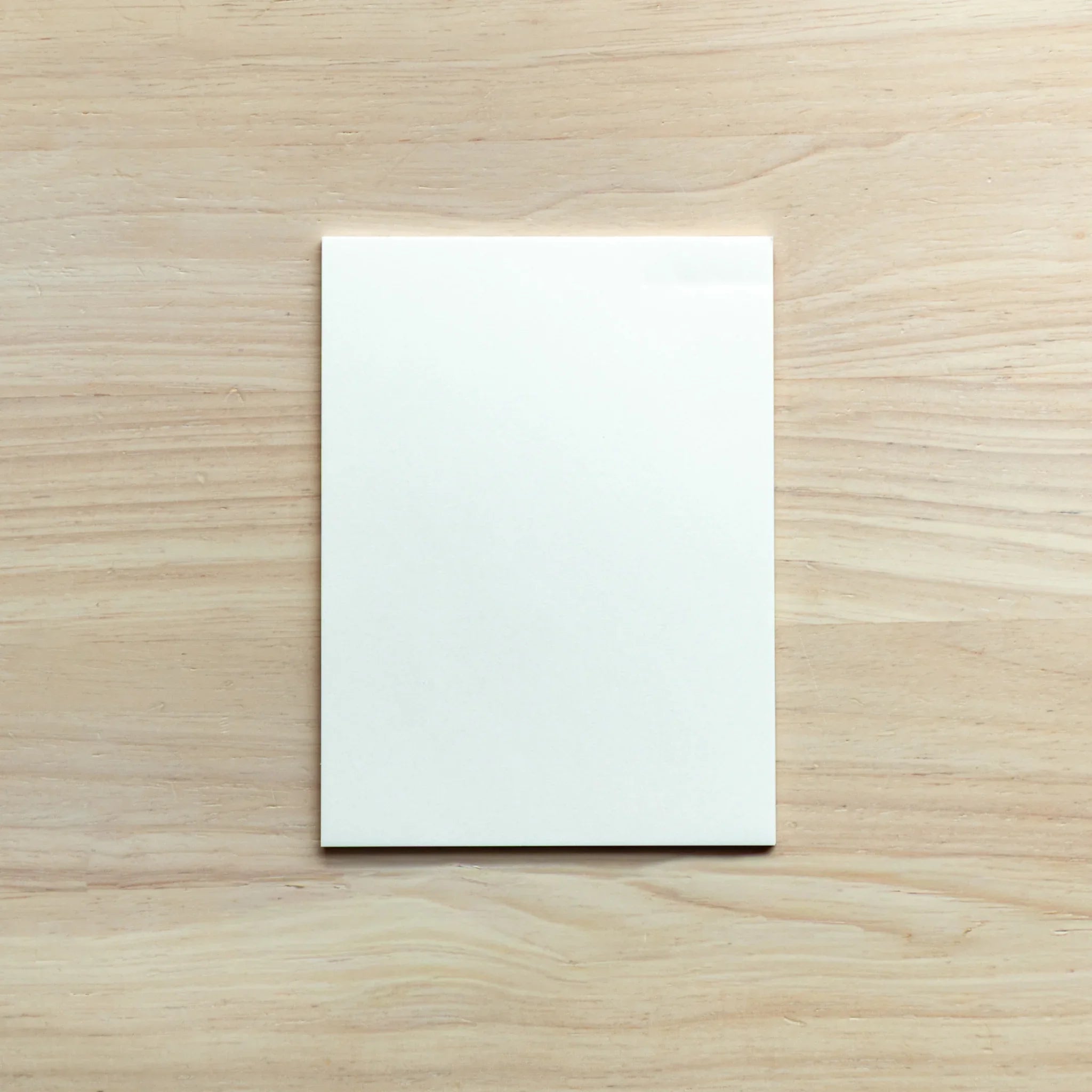 Stacked paper pads from Translucent set showing individual sheet thickness and light transmitting transparency property