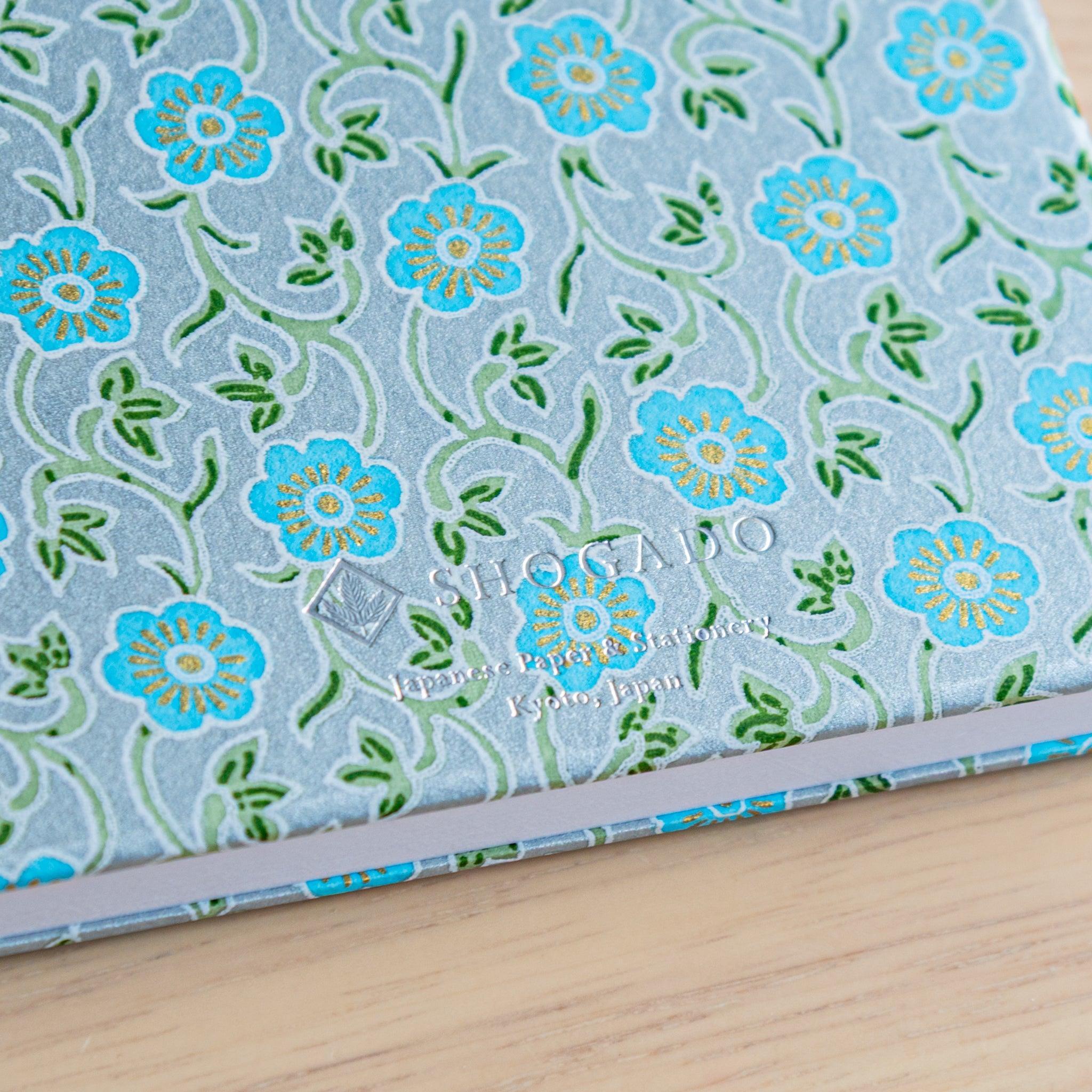 Close-up of blue floral washi Goshuinsho stamp book by SHOGADO, a Japanese stationery brand from Kyoto.