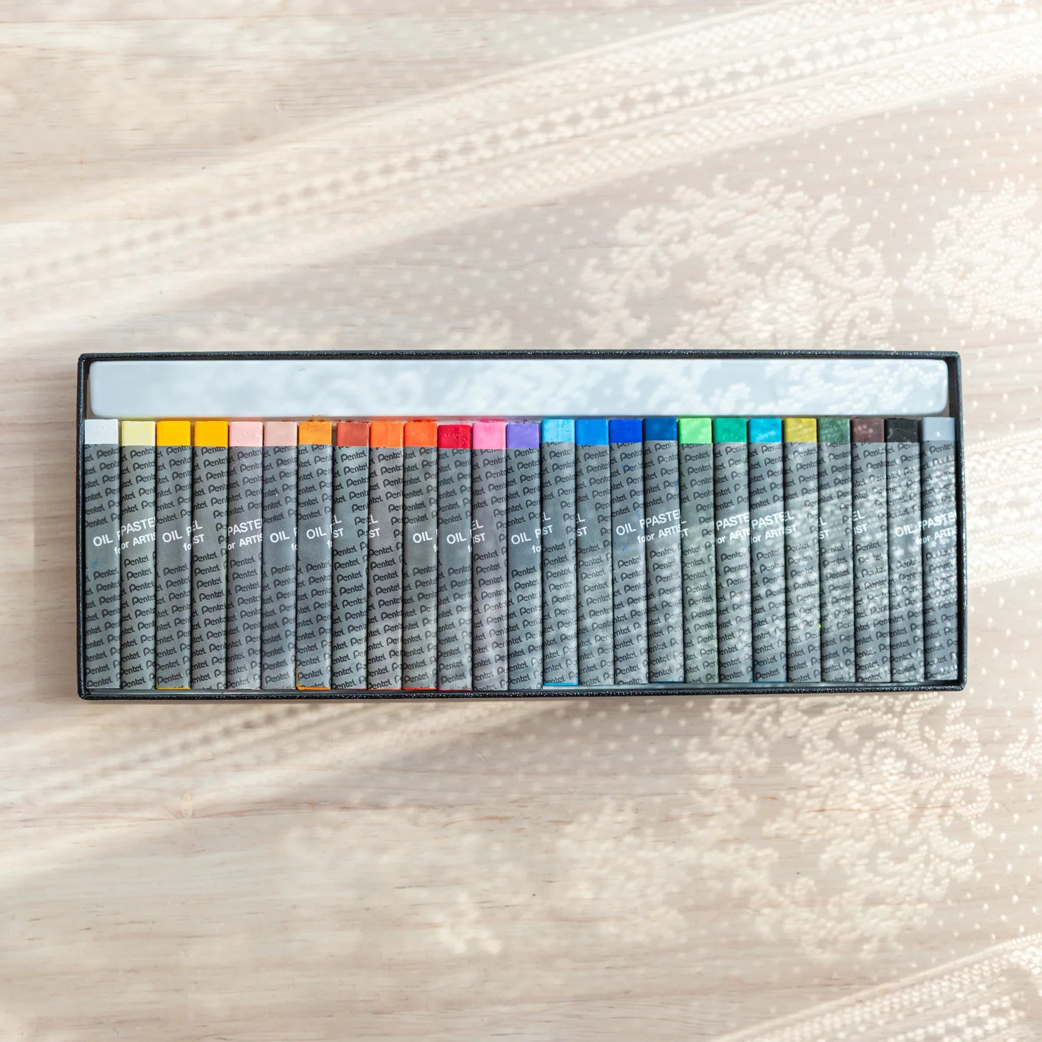 Pentel Oil Pastels for Artists Set (25 Colors) - oil pastel crayon showing side angle showing product depth and construction