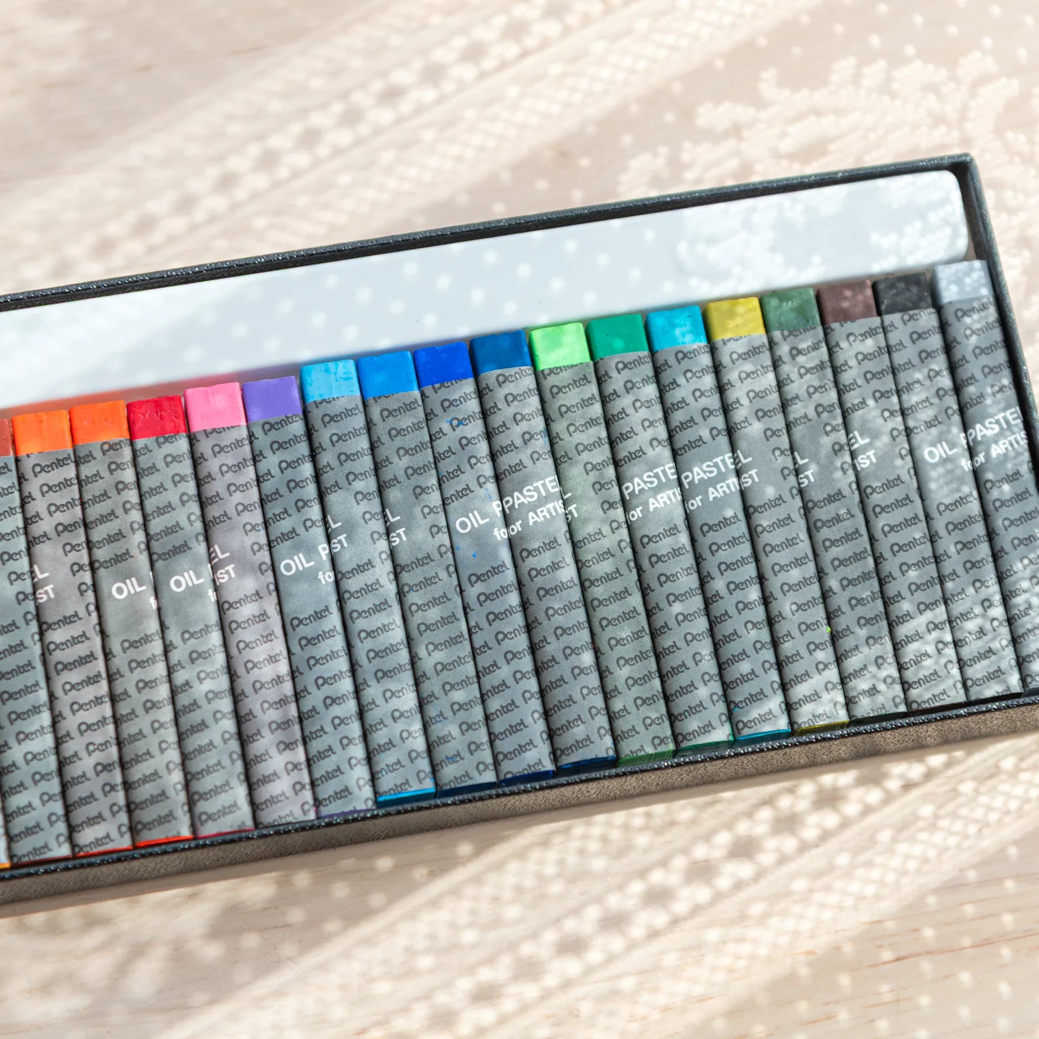Cool-toned Pentel Japanese Oil Pastels in a box, adding variety to arts and crafts projects.