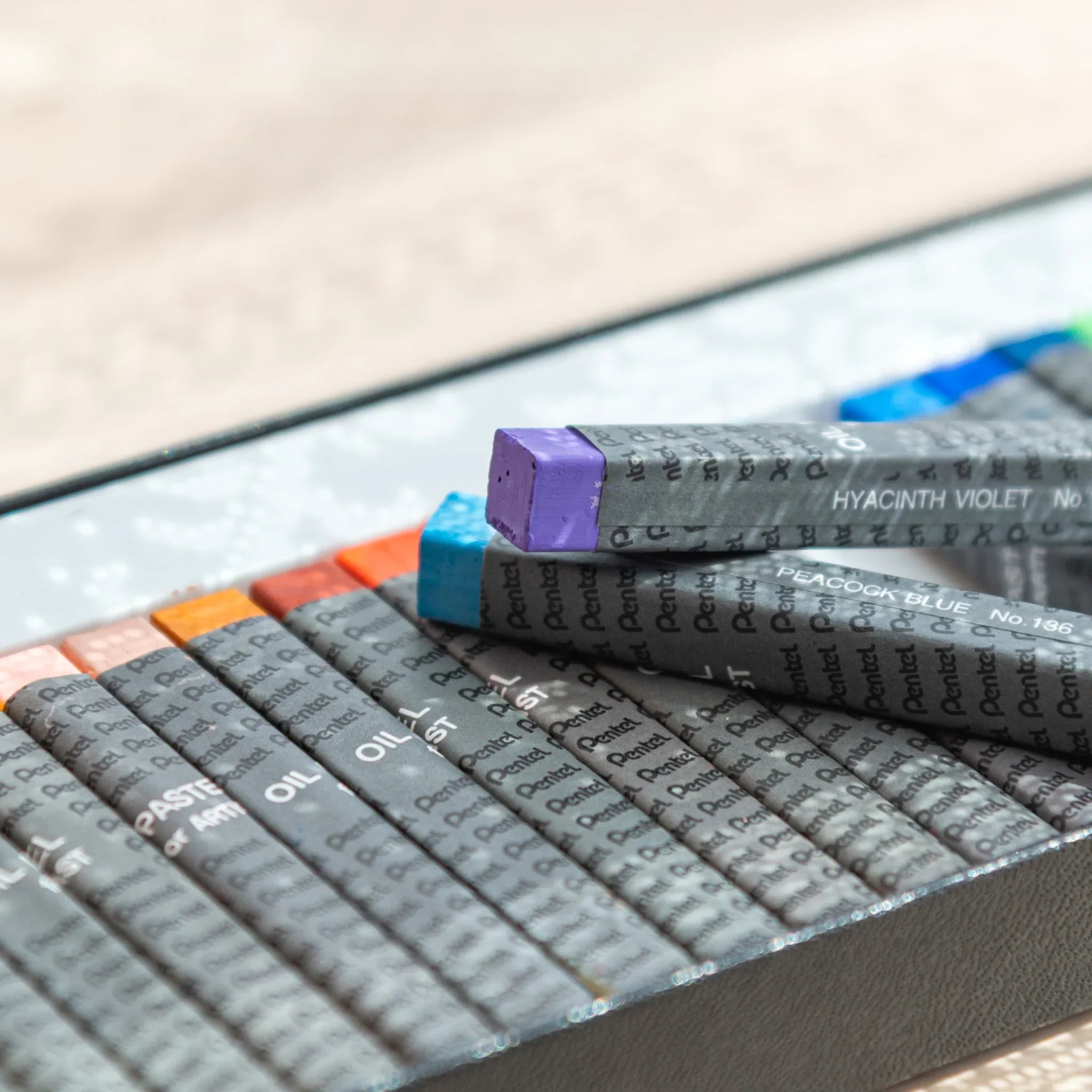 Diagonal placement of blue and violet Pentel Japanese Oil Pastels adds flair to arts and crafts.