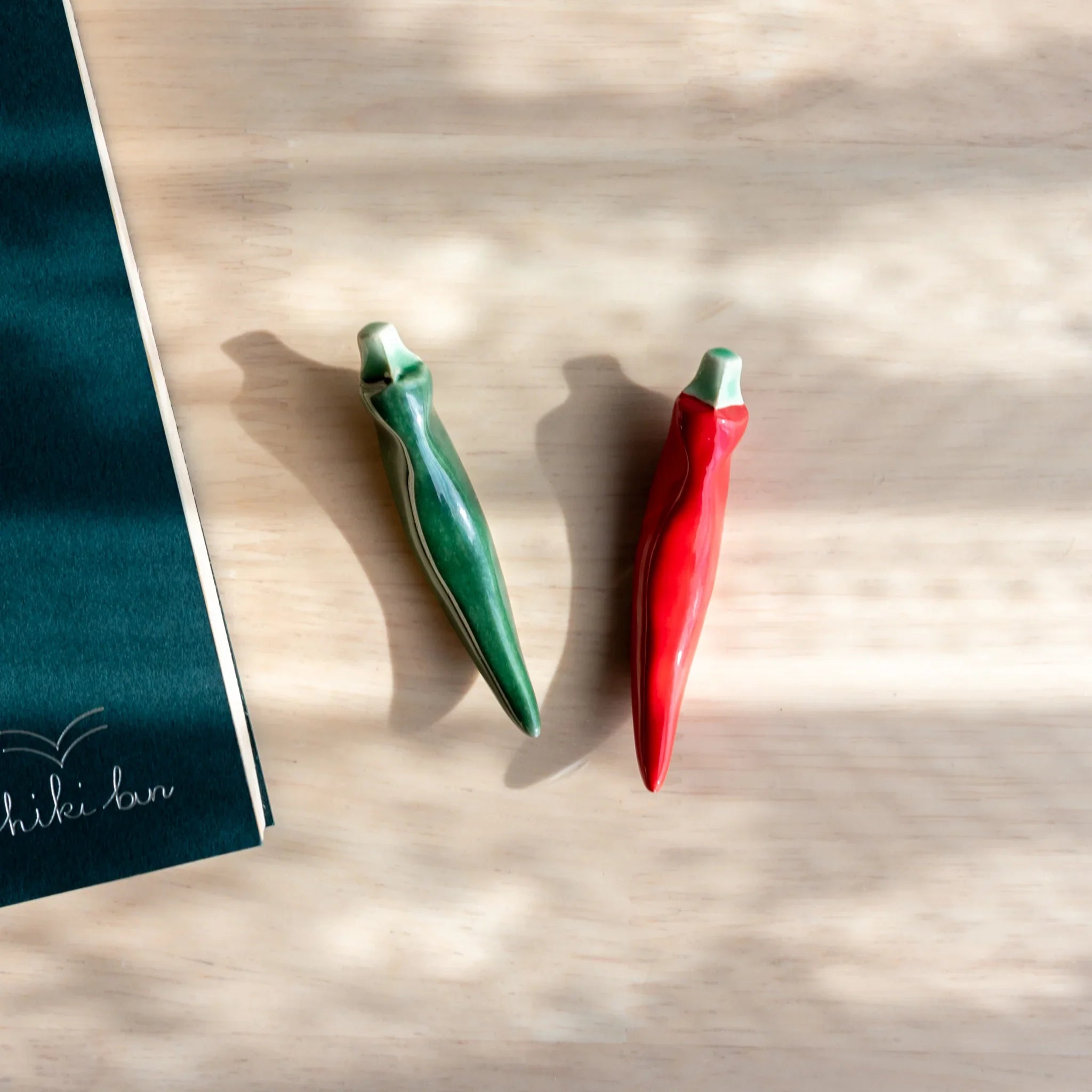 Dango pen rest collection displaying pink, white and green color variations with wooden skewer supports on neutral surface