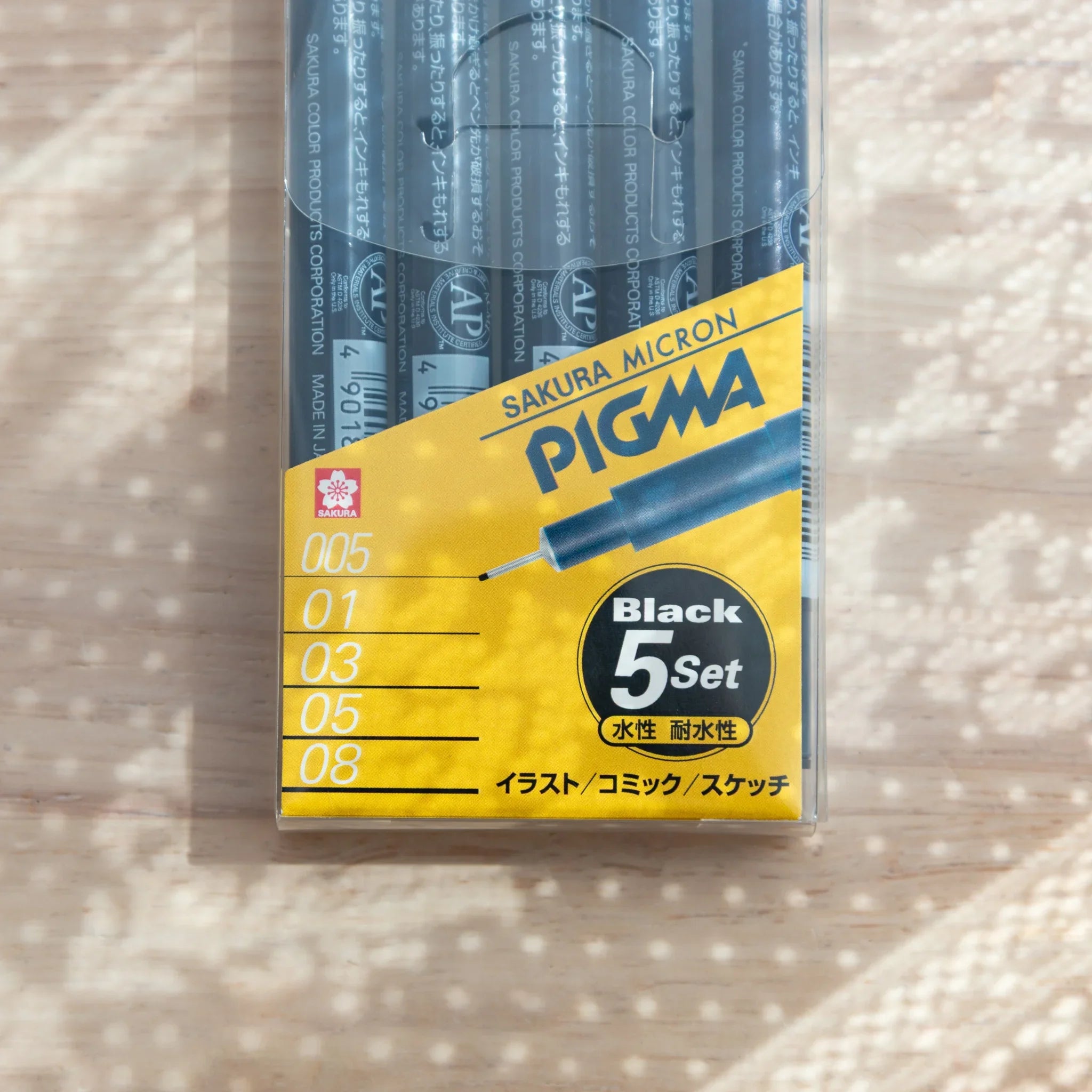 Front label of Sakura Micron Pigma Black 5-pen set showing Sakura logo, size list 005 through 08, and Black 5Set badge