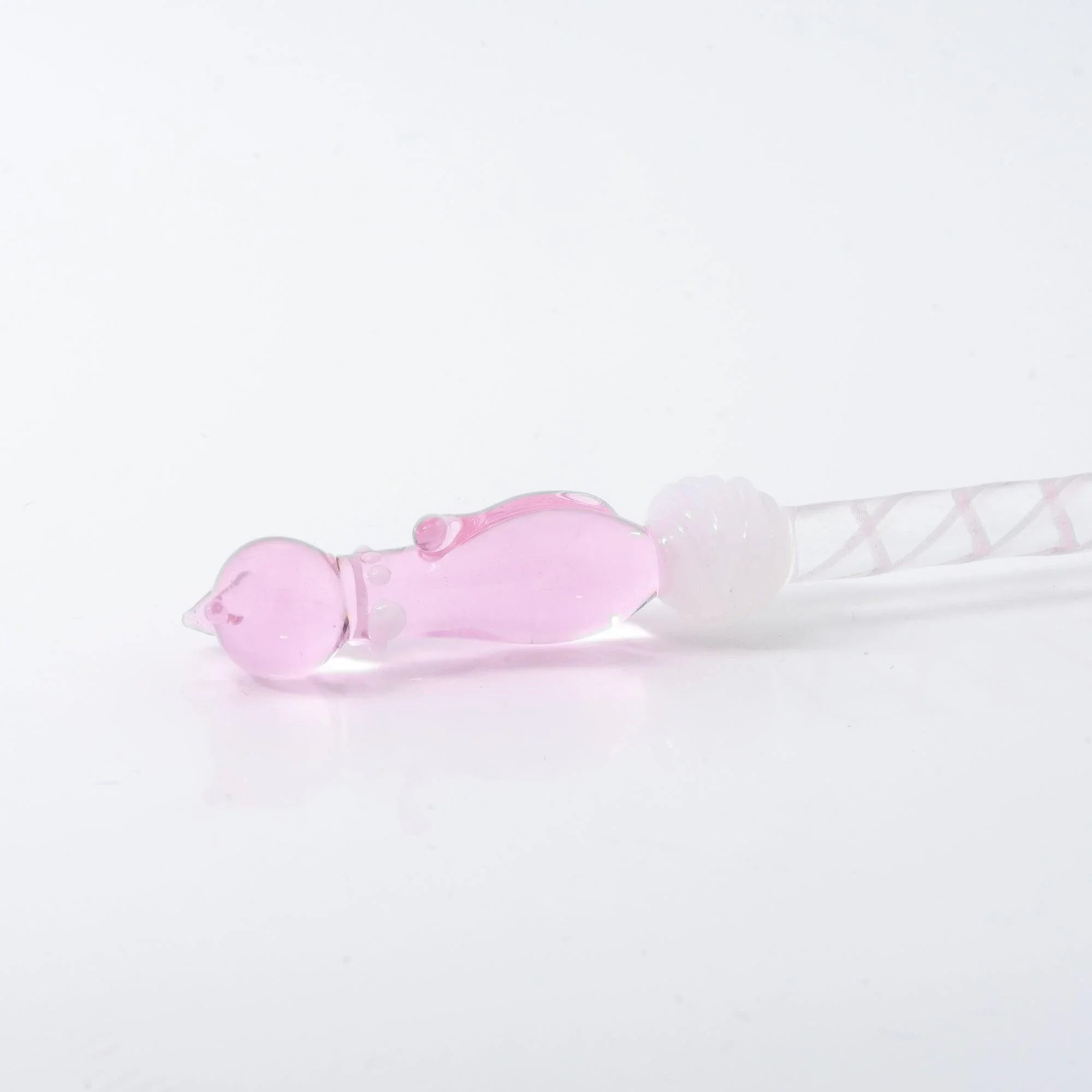 Pink sitting cat Nyanko figure detail angled view on transparent pink glass dip pen with Japanese handle