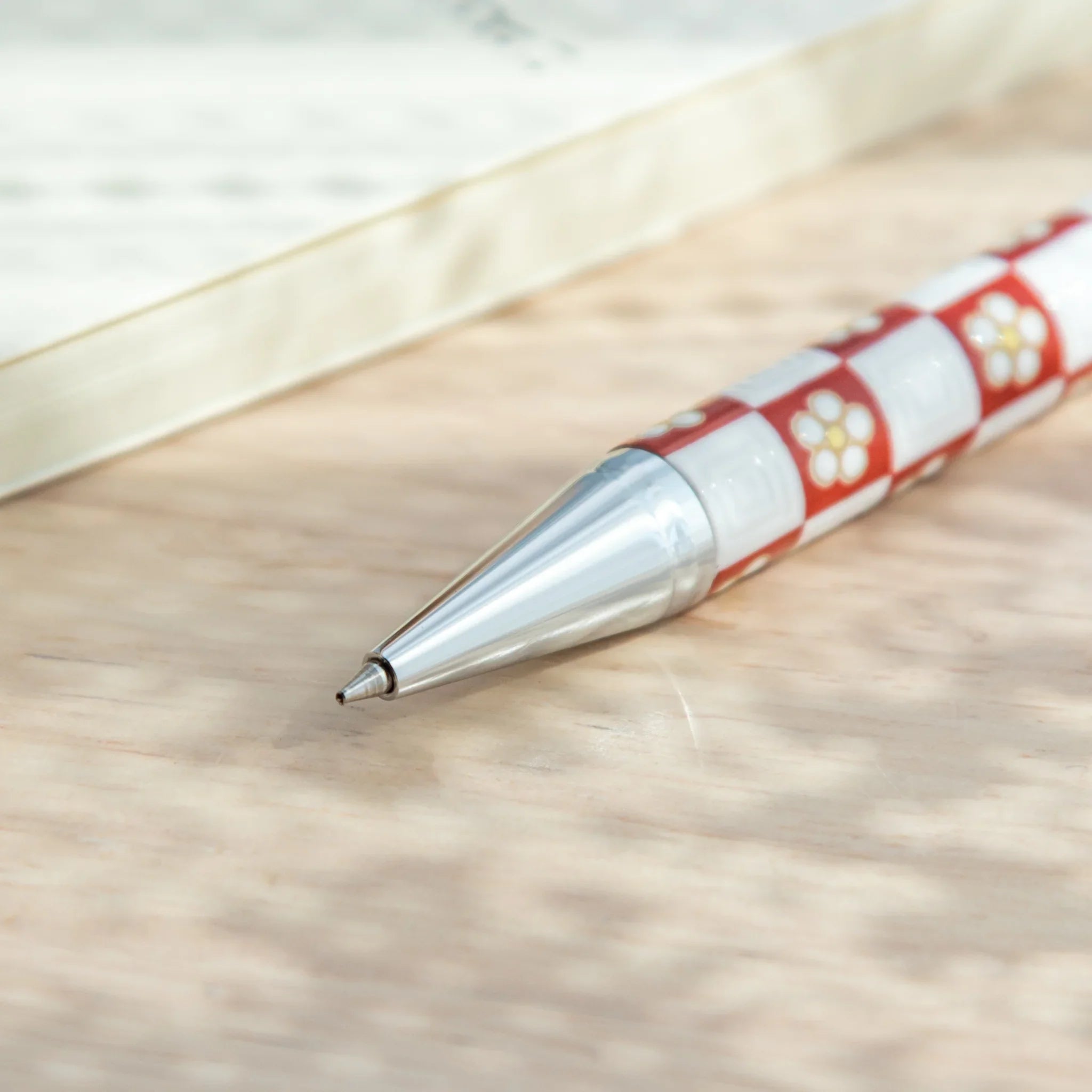 Hand-painted plum blossom Kutani ballpoint pen combining floral design with modern function for refined desk organization