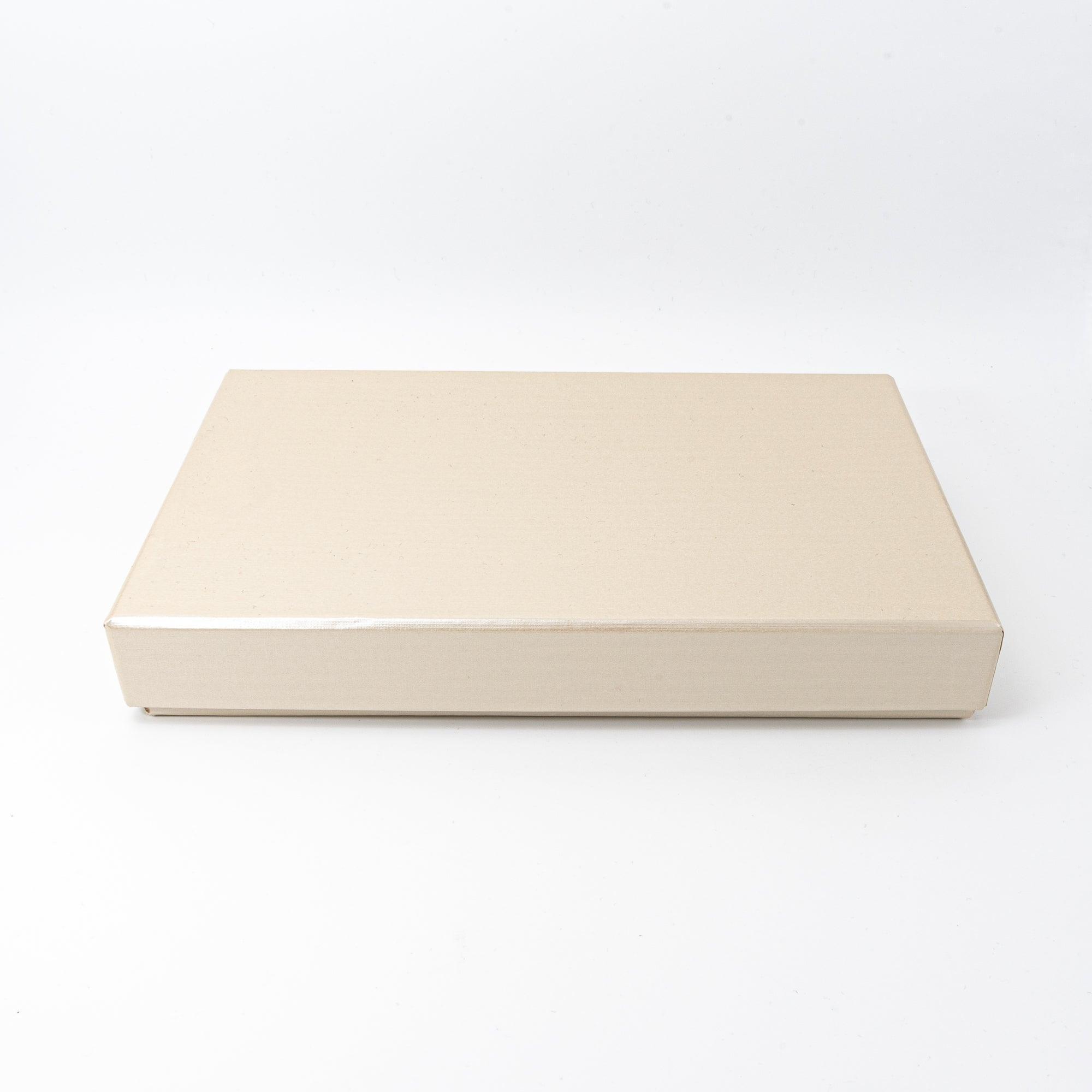 A simple beige box with a smooth surface, designed for storing or gifting decorative items with sophistication.