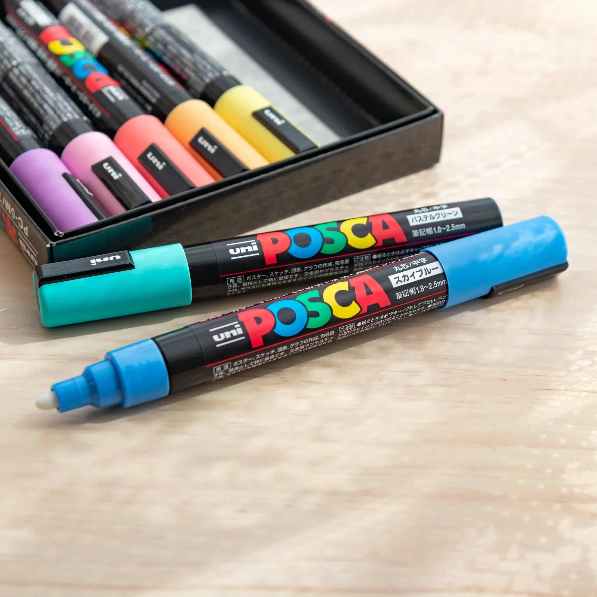 POSCA Markers Set (Medium Bullet Tip, 7 Colors) - paint marker showing in-use demonstration with writing on paper surface