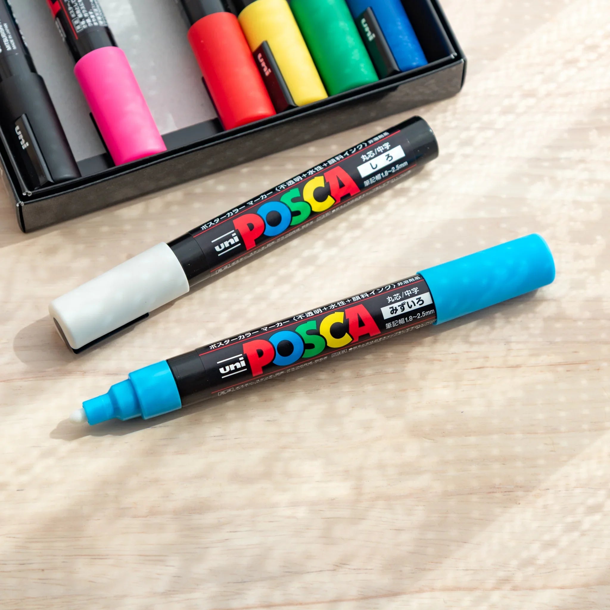 POSCA Markers Set (Medium Bullet Tip, 8 Colors) - paint marker showing in-use demonstration with writing on paper surface