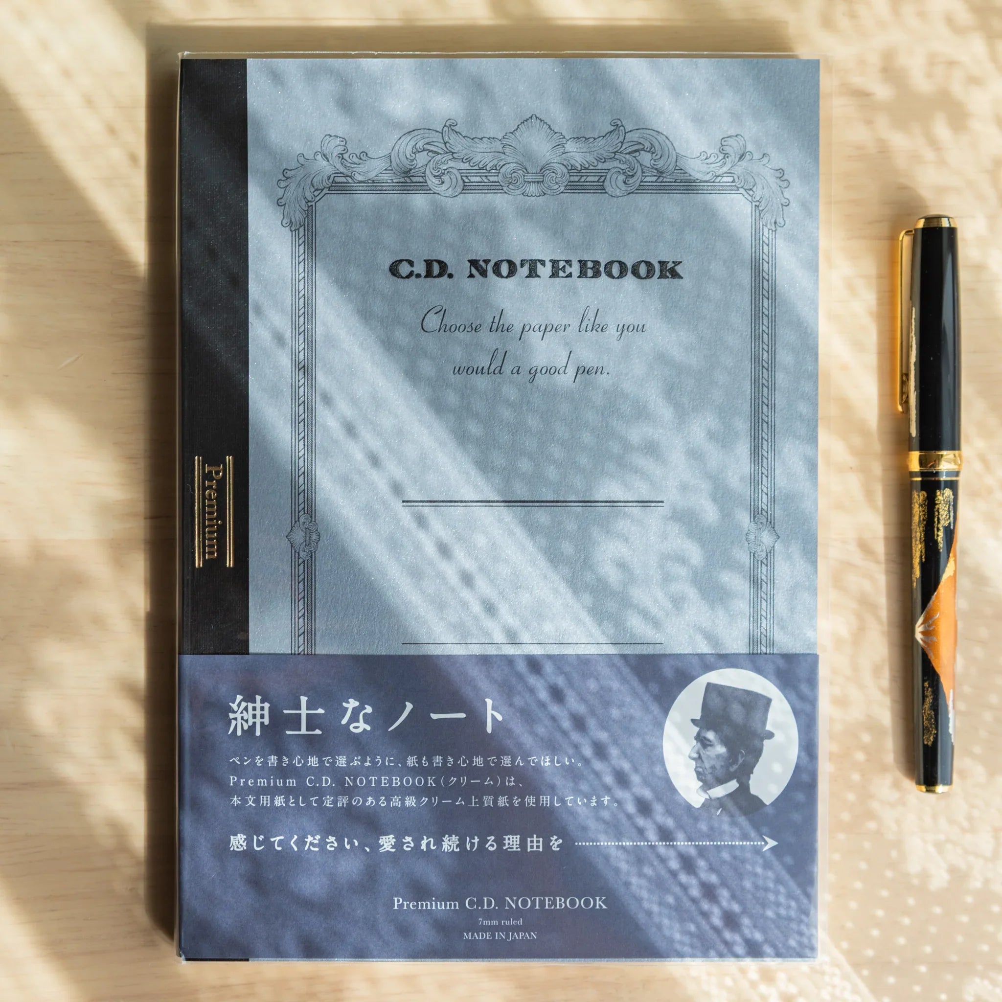 Premium CD fountain pen notebook A5 cream with open flat lay displaying light blue interior pages and ruled pattern