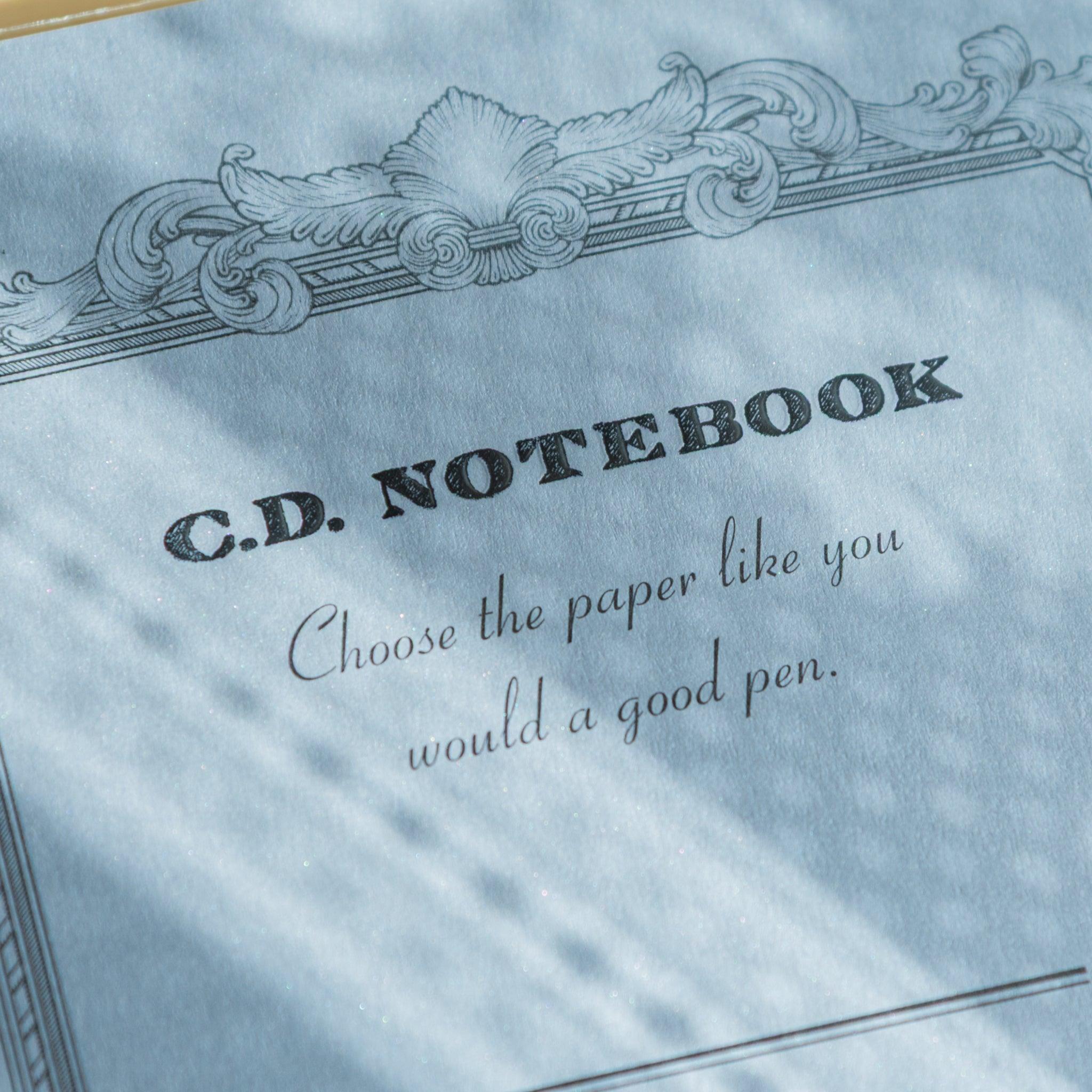 Close-up of cover text on a blue Premium C.D. Japanese notebook, with elegant quote and textured paper for fountain pen use.