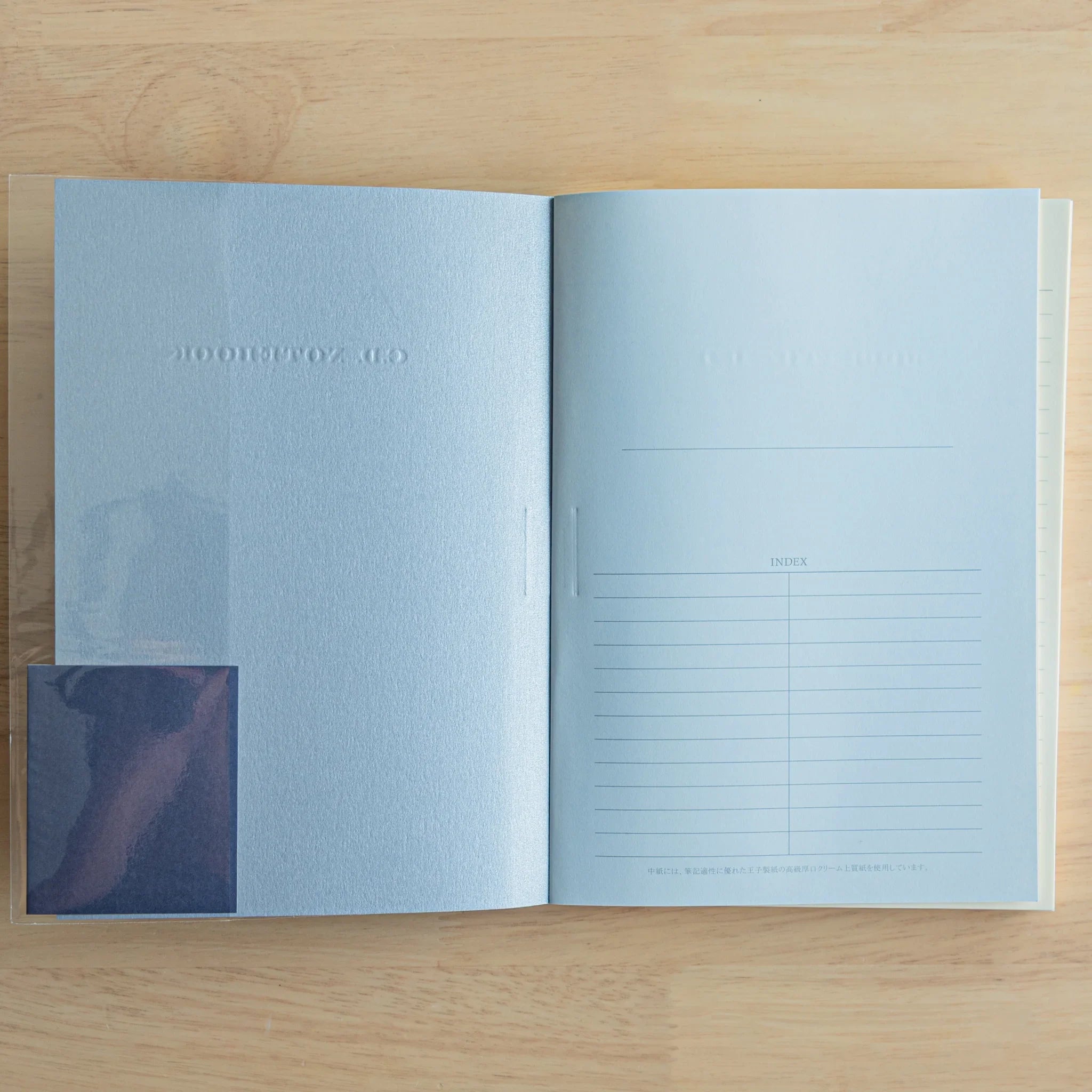 Apica Premium CD A5 soft cover notebook cream with interior blue pages open showing fine ruled line pattern and design