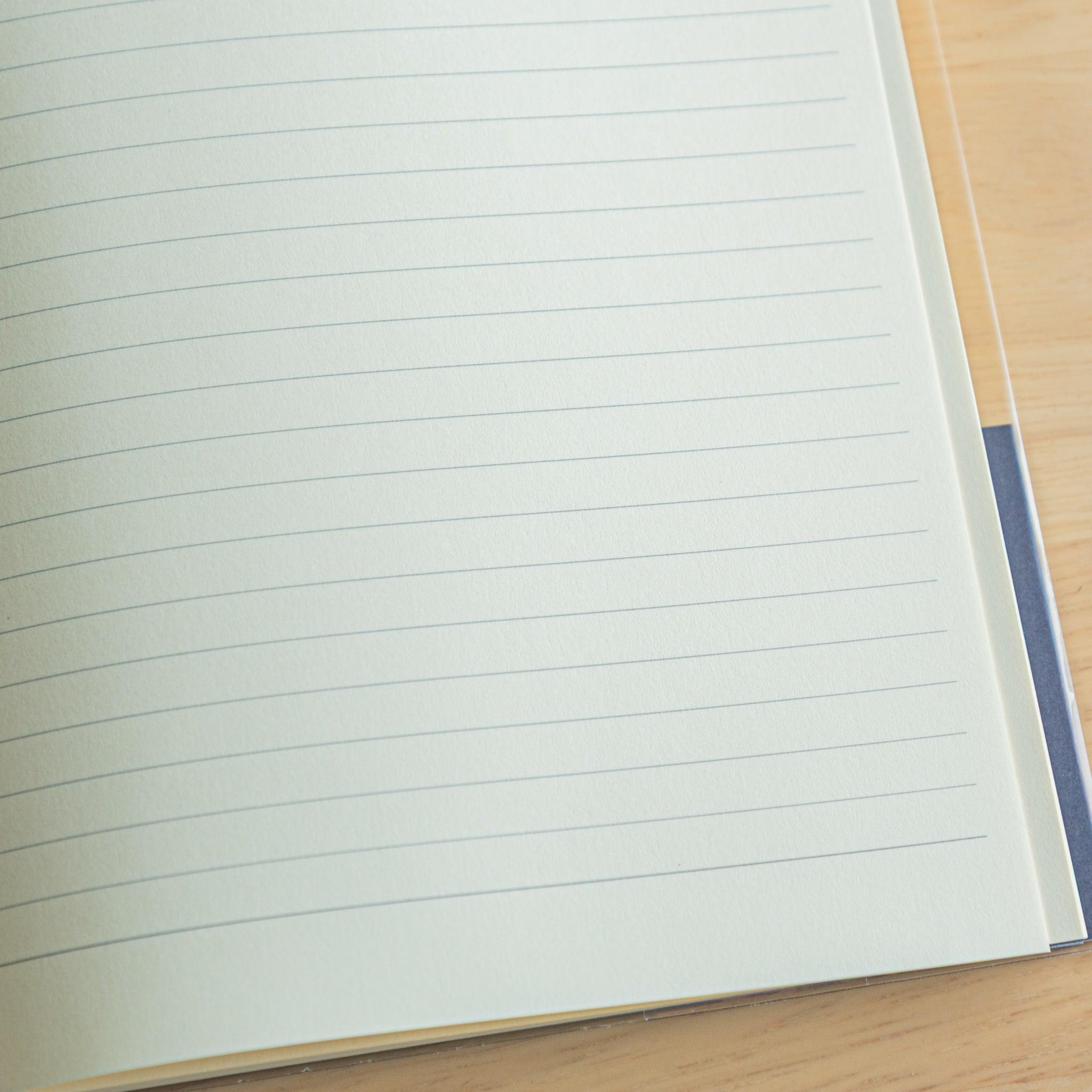 Close-up of lined cream paper in a Japanese notebook, designed for comfortable writing and fountain pen ink compatibility