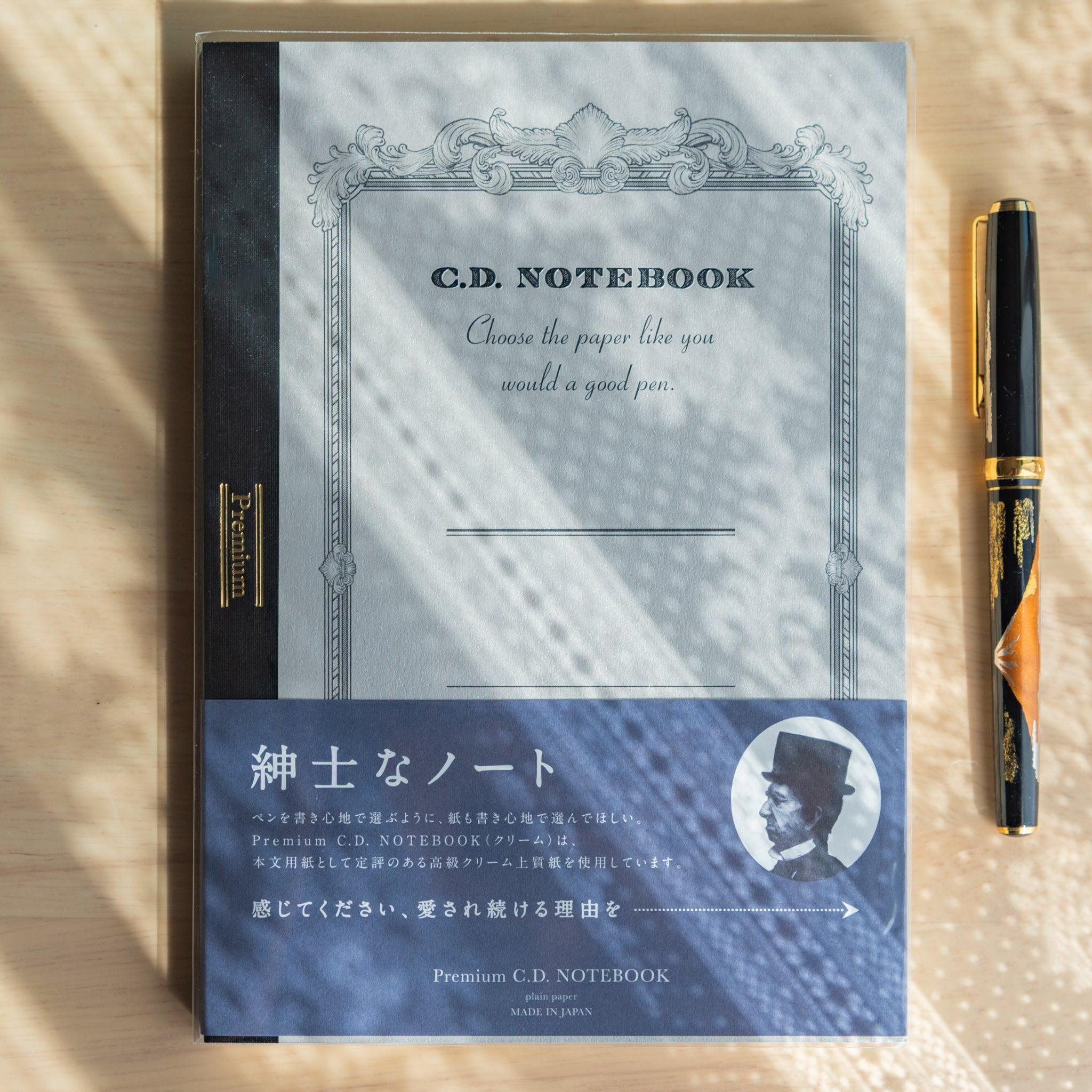 Premium C.D. Japanese notebook and a fountain pen on a desk, showcasing elegant design and premium Japanese stationery appeal