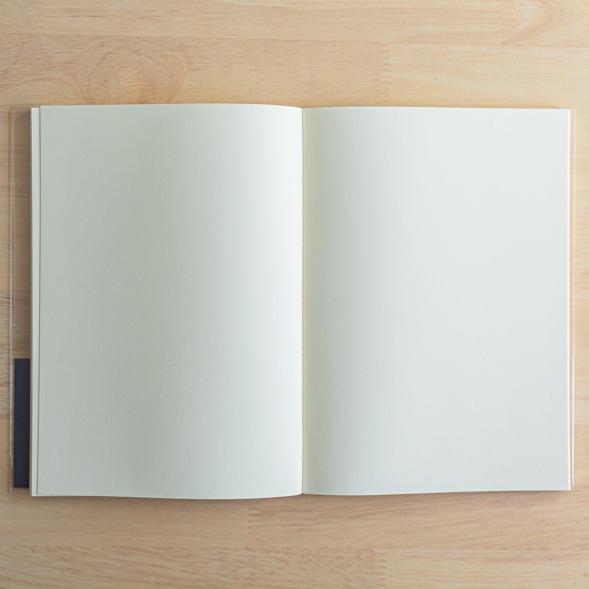 Open Premium C.D. Japanese notebook showing two blank cream pages, ideal for fountain pen use and smooth writing
