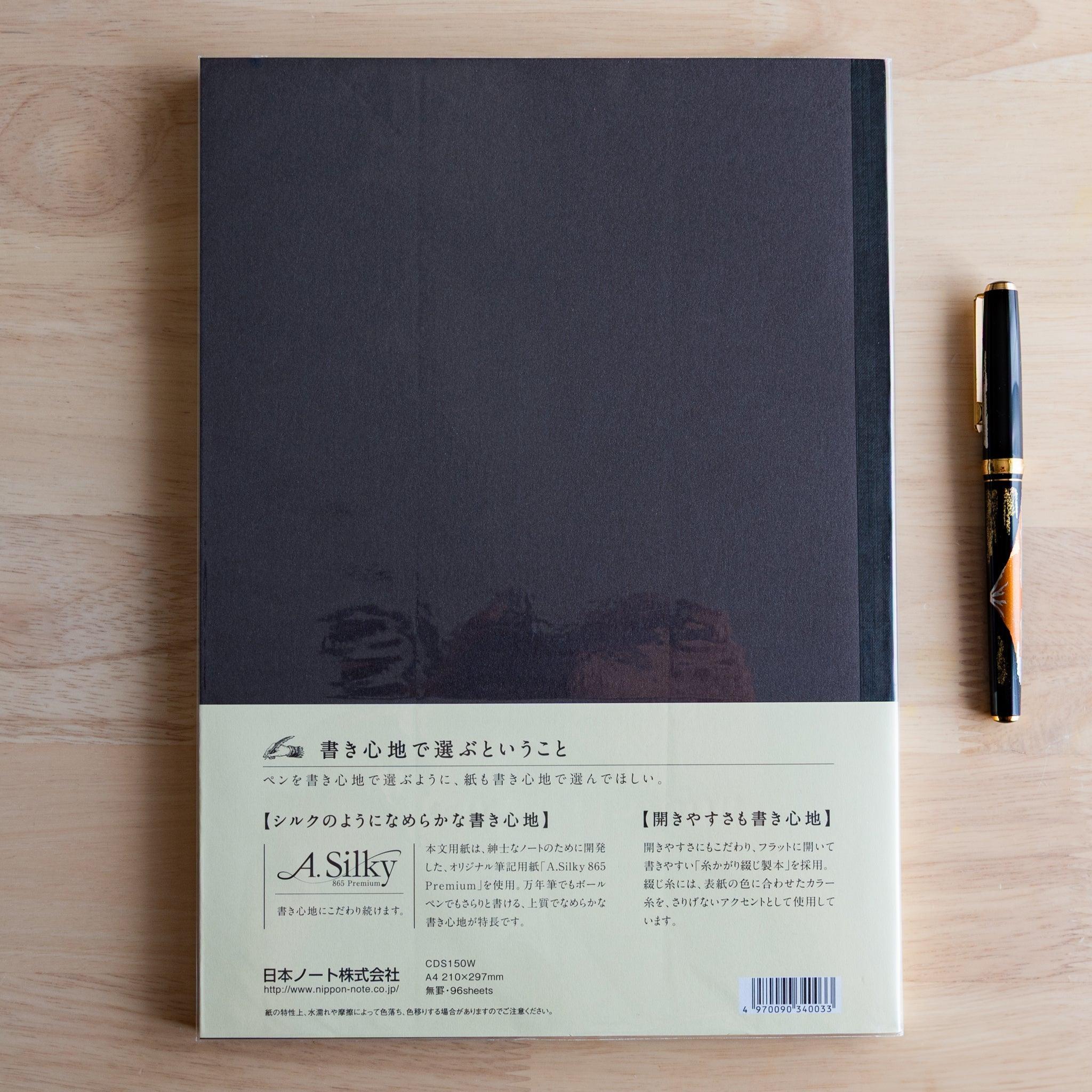 Back of black Premium C.D. Japanese notebook with cream label explaining A.Silky 865 Premium paper.