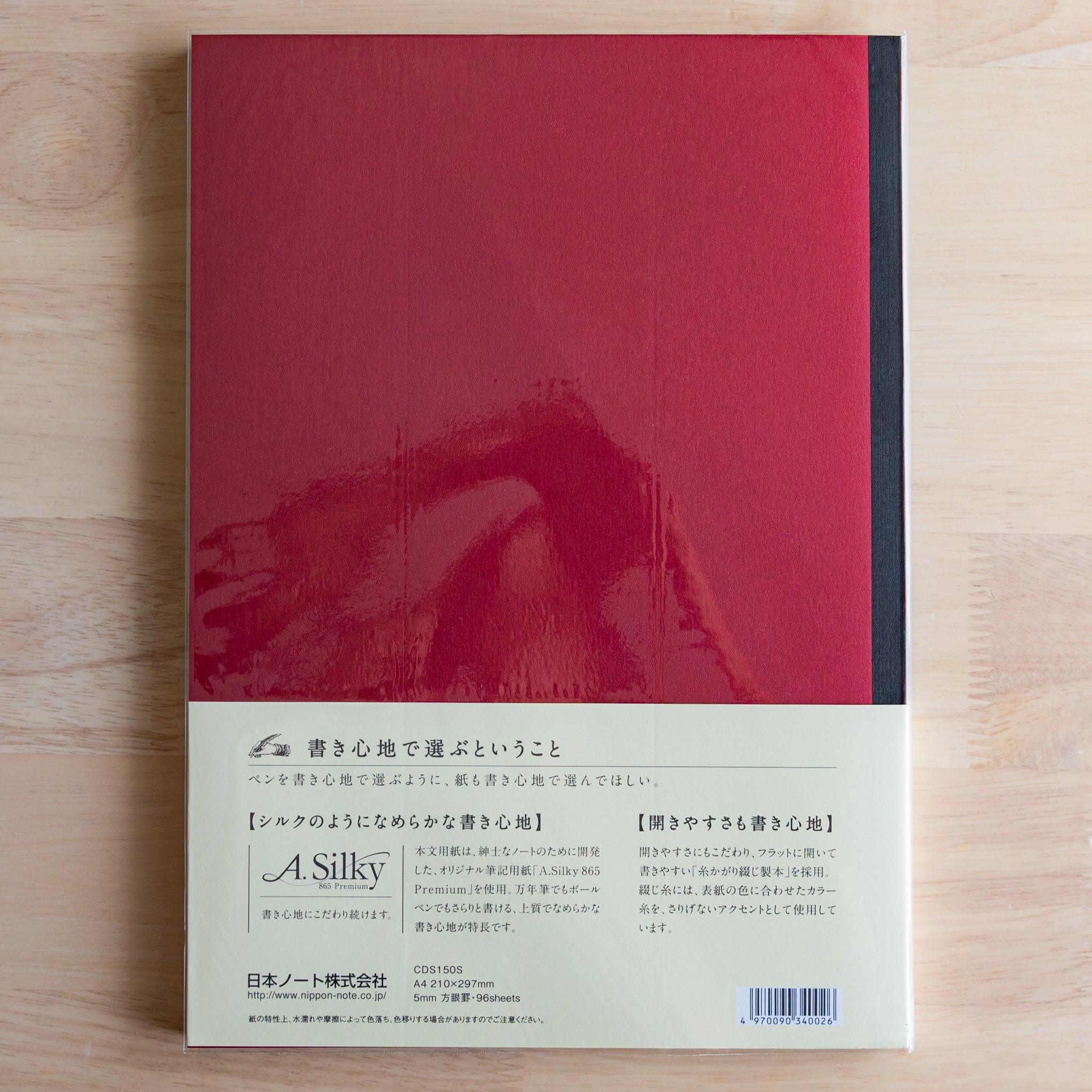 Back of red Premium C.D. Japanese notebook with cream label explaining A.Silky 865 Premium paper.