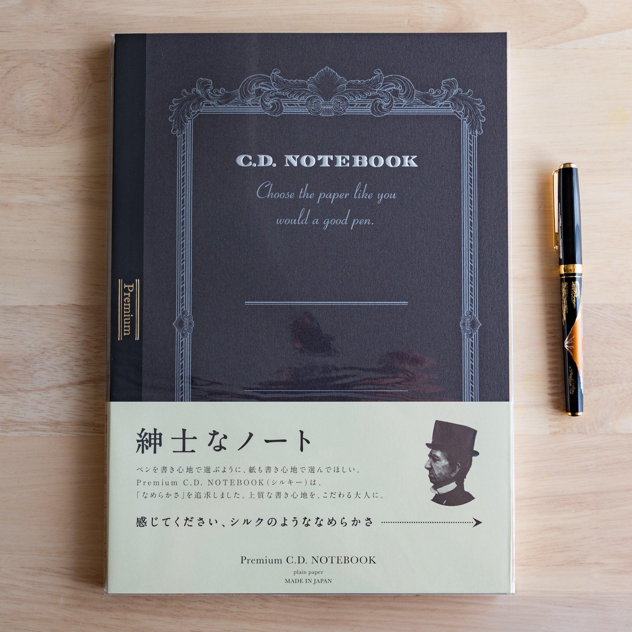 Black A4 Premium CD Japanese notebook with cream band and fountain pen, highlighting its elegant paper for pen lovers.