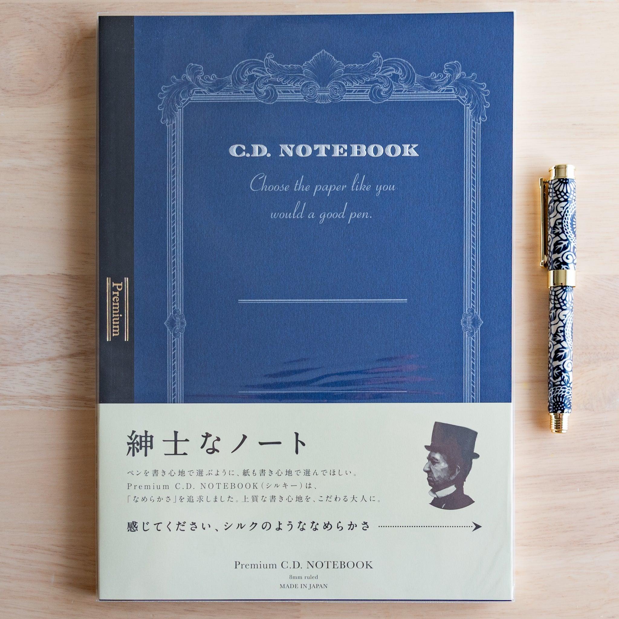Blue A4 Premium CD Japanese notebook with cream band and fountain pen, highlighting its elegant paper for pen lovers.