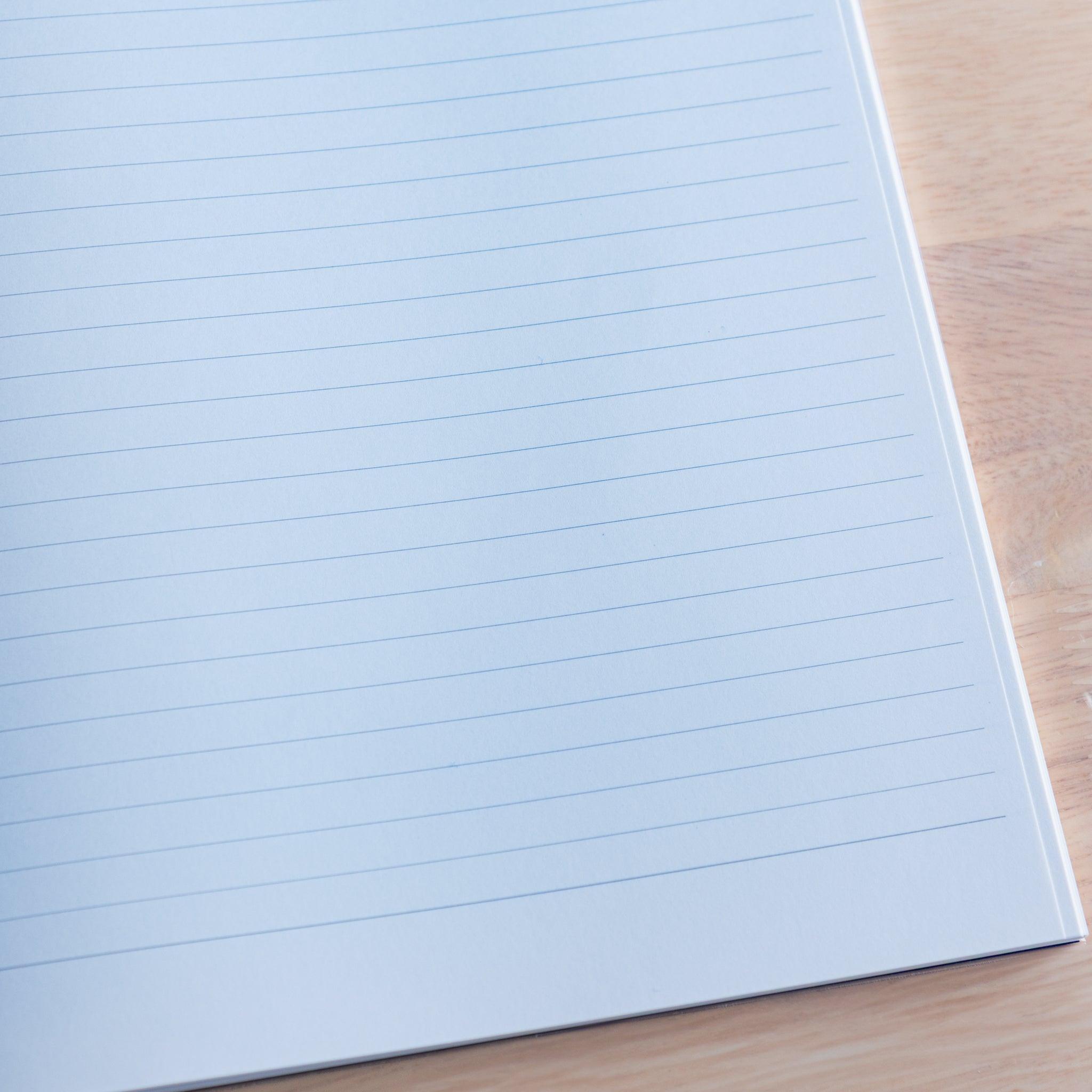Close-up of lined white page in a Premium CD Japanese notebook, featuring smooth texture for fountain pen writing.