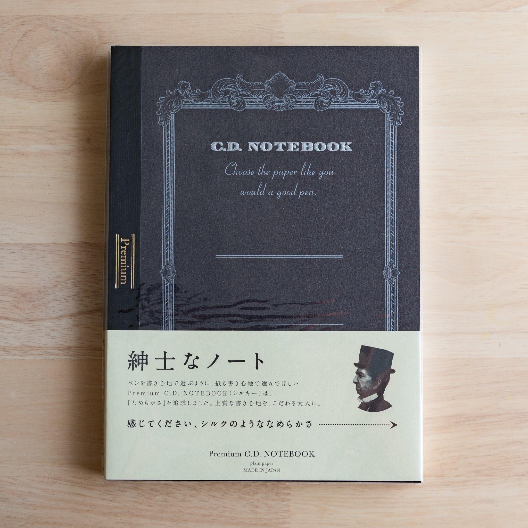 Black B5 Premium CD Japanese notebook with cream band and fountain pen, highlighting its elegant paper for pen lovers.
