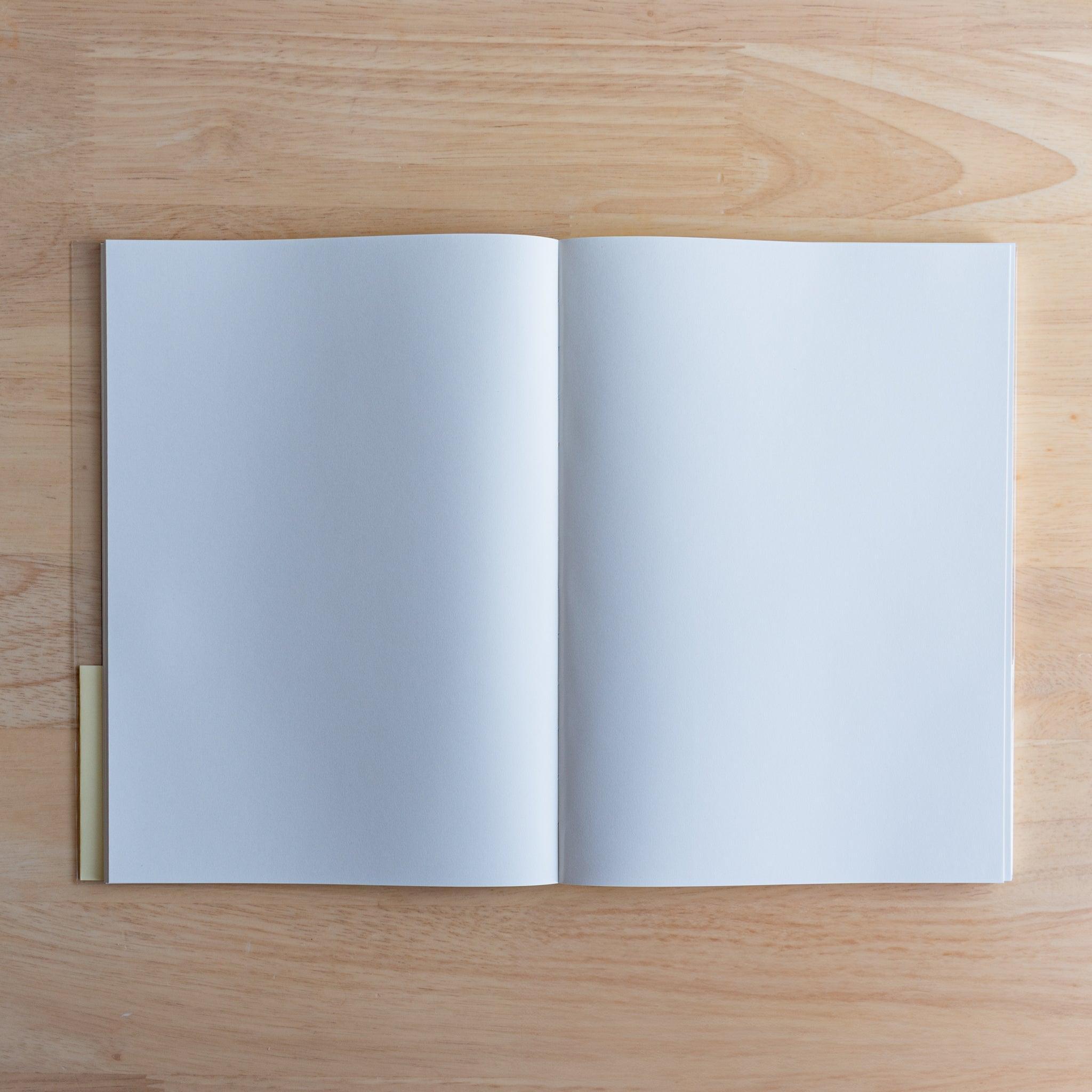 Open Premium C.D. Japanese notebook showing two plain white pages, made for smooth writing with fountain pens.