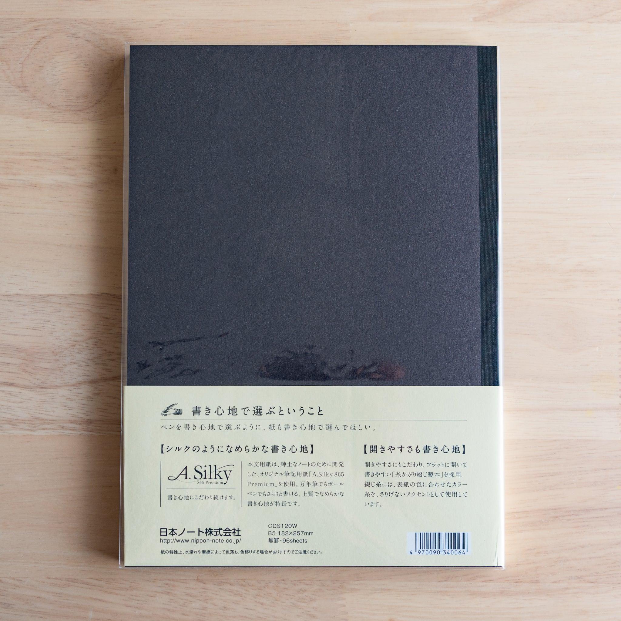 Back of black Premium C.D. Japanese notebook with cream label explaining A.Silky 865 Premium paper.