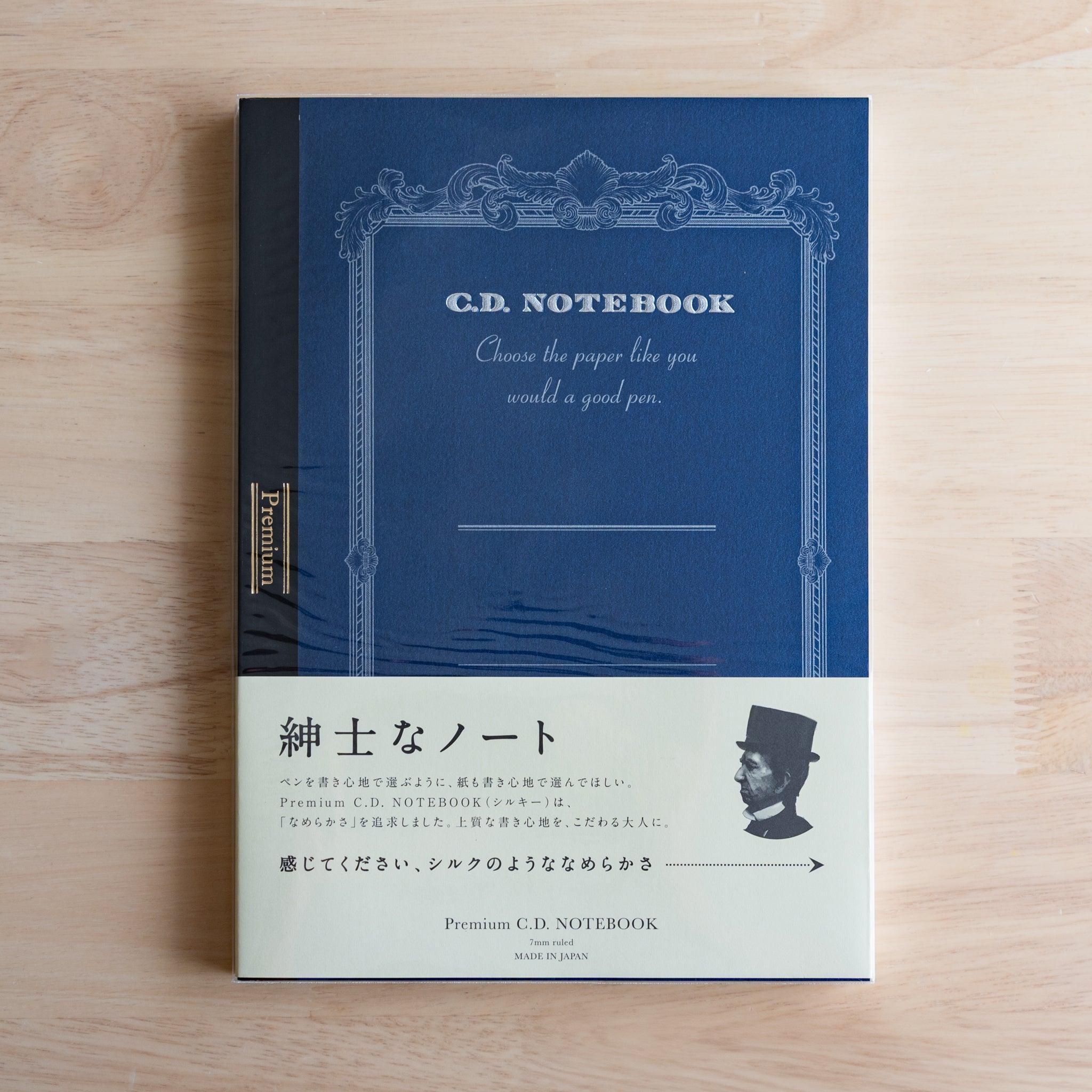 Blue B5 Premium CD Japanese notebook with cream band and fountain pen, highlighting its elegant paper for pen lovers.