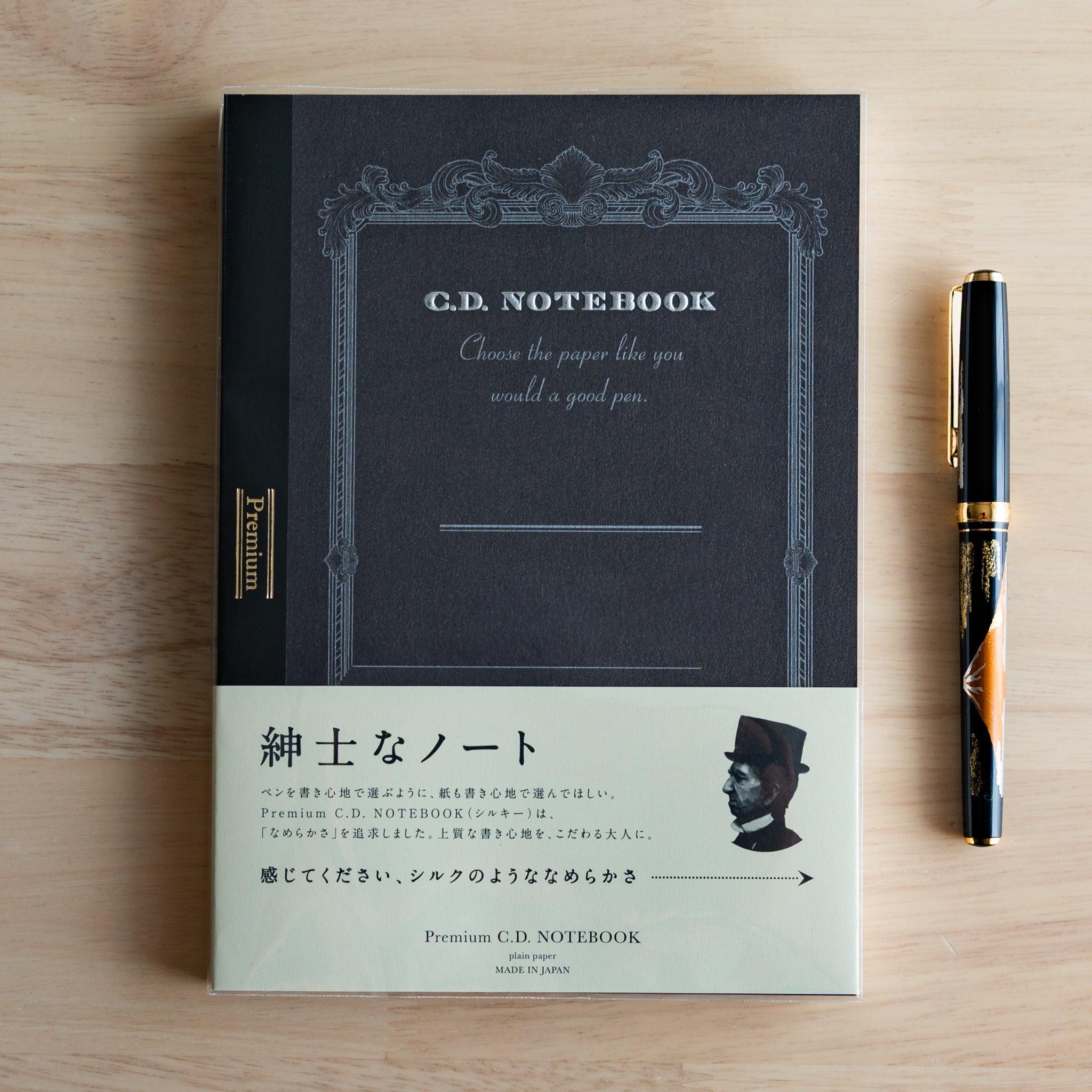 Black A5 Premium CD Japanese notebook with cream band and fountain pen, highlighting its elegant paper for pen lovers.