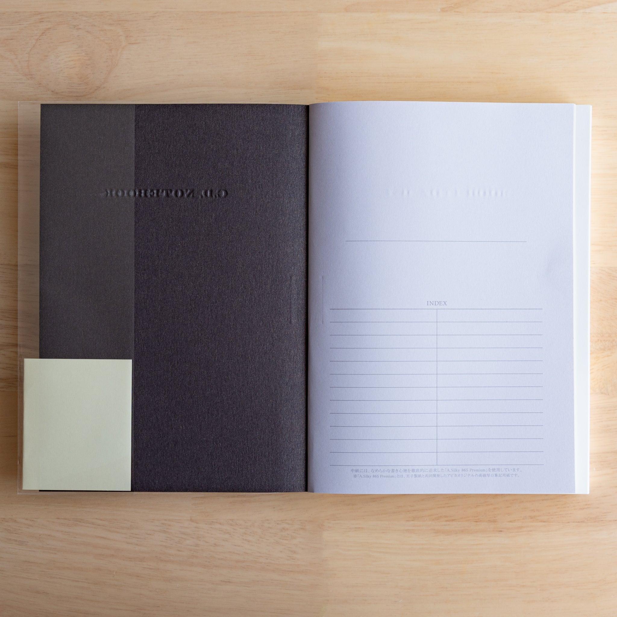 Inside view of a black Premium CD Japanese notebook showing textured inner cover and index page.