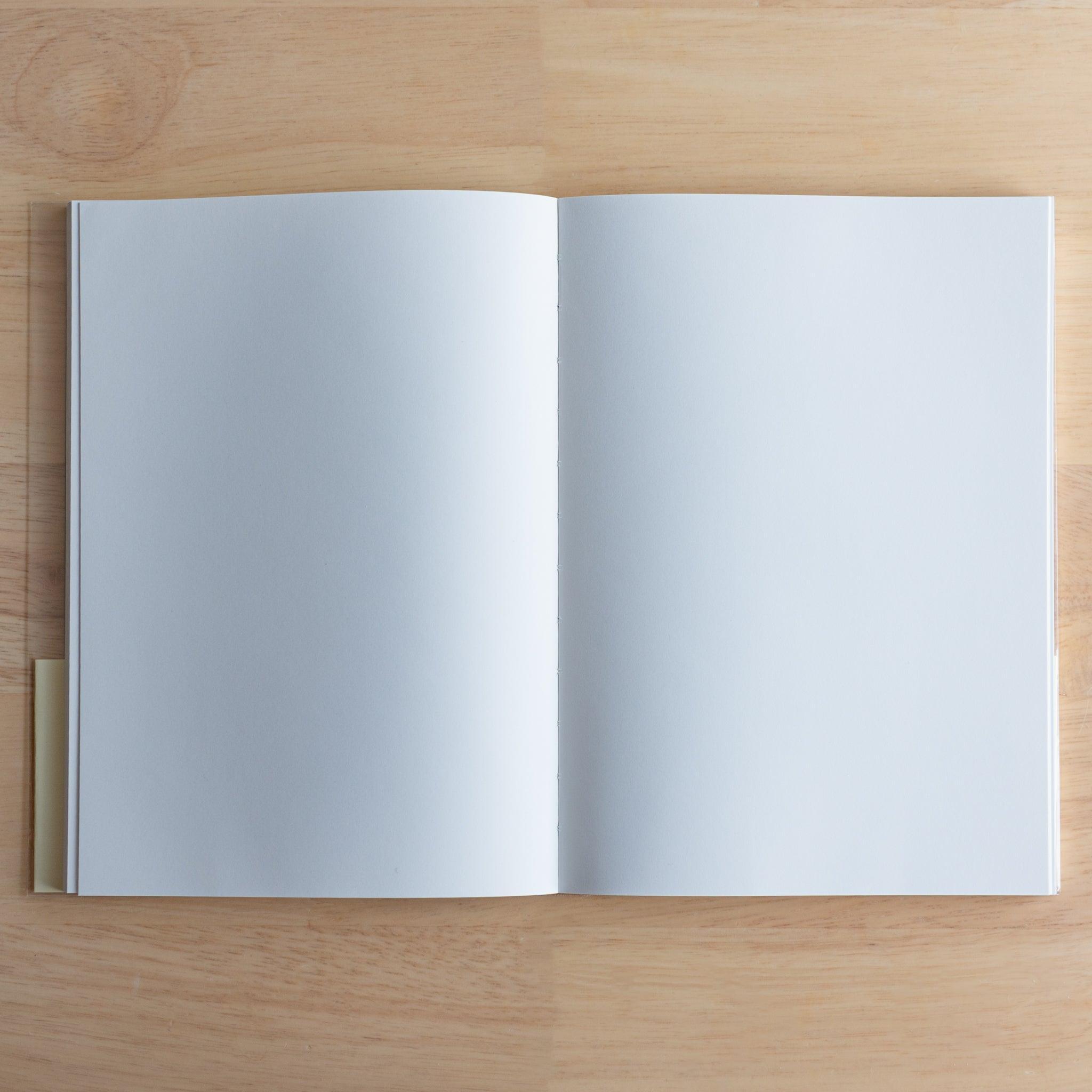 Open Premium C.D. Japanese notebook showing two plain white pages, made for smooth writing with fountain pens.