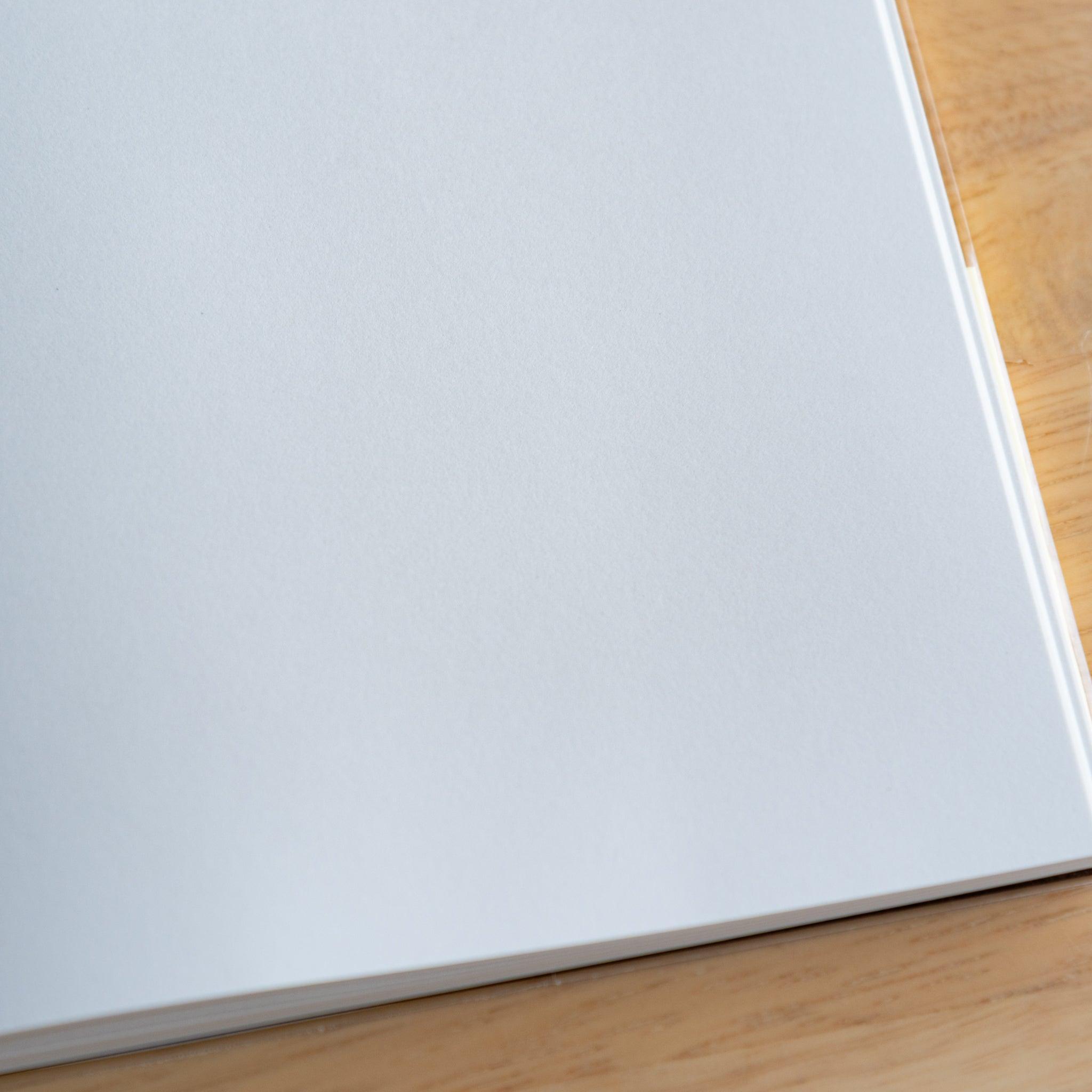Close-up of blank white page in a Premium CD Japanese notebook, featuring smooth texture for fountain pen writing.