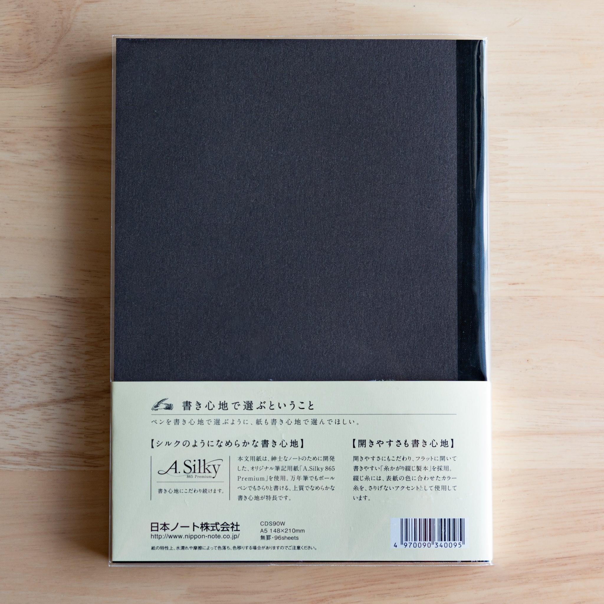Back of black Premium C.D. Japanese notebook with cream label explaining A.Silky 865 Premium paper.