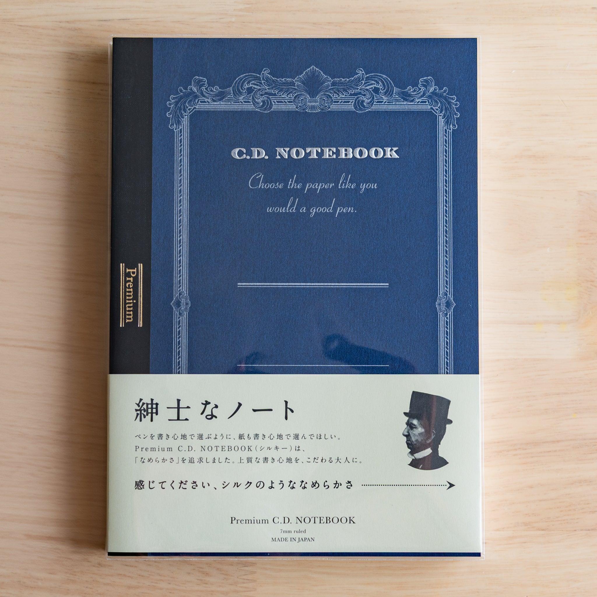 Blue A5 Premium CD Japanese notebook with cream band and fountain pen, highlighting its elegant paper for pen lovers.